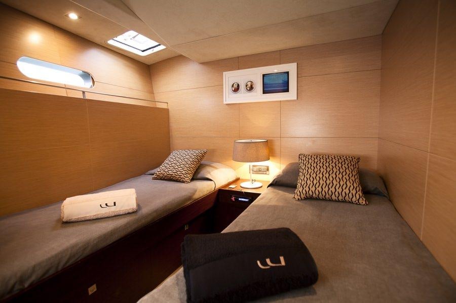 a hotel room with two beds aboard WIZARD Yacht for Charter