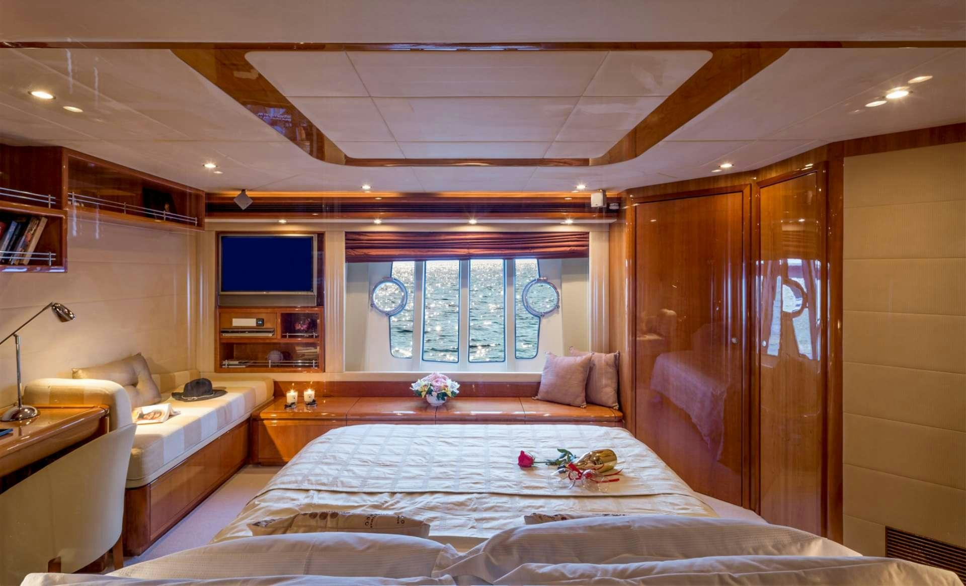 a bedroom with a large mirror aboard PIOLA Yacht for Charter
