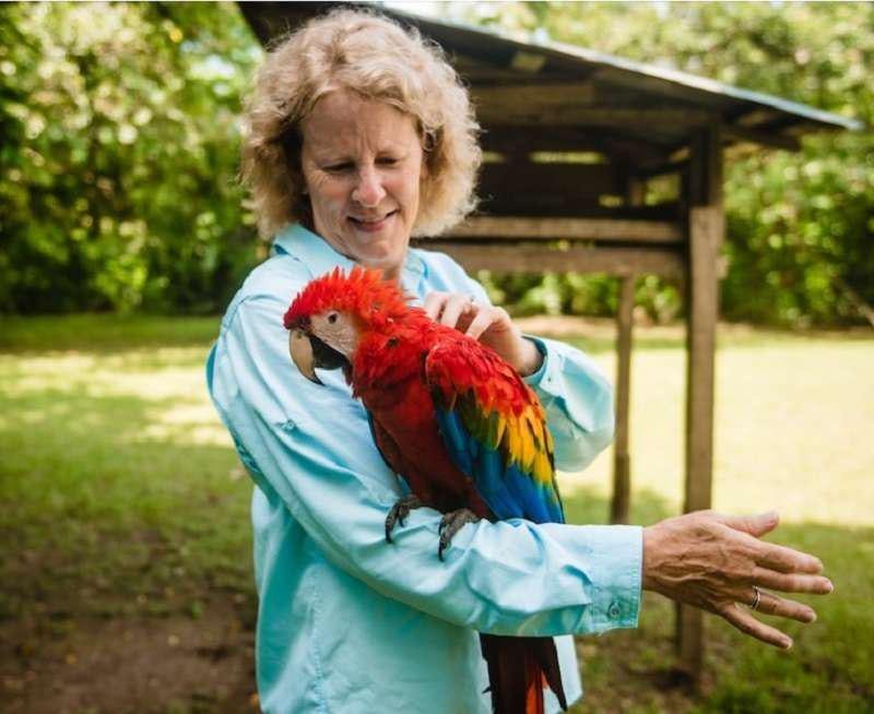 a person holding a parrot aboard CRUCERO AMAZONAS Yacht for Charter