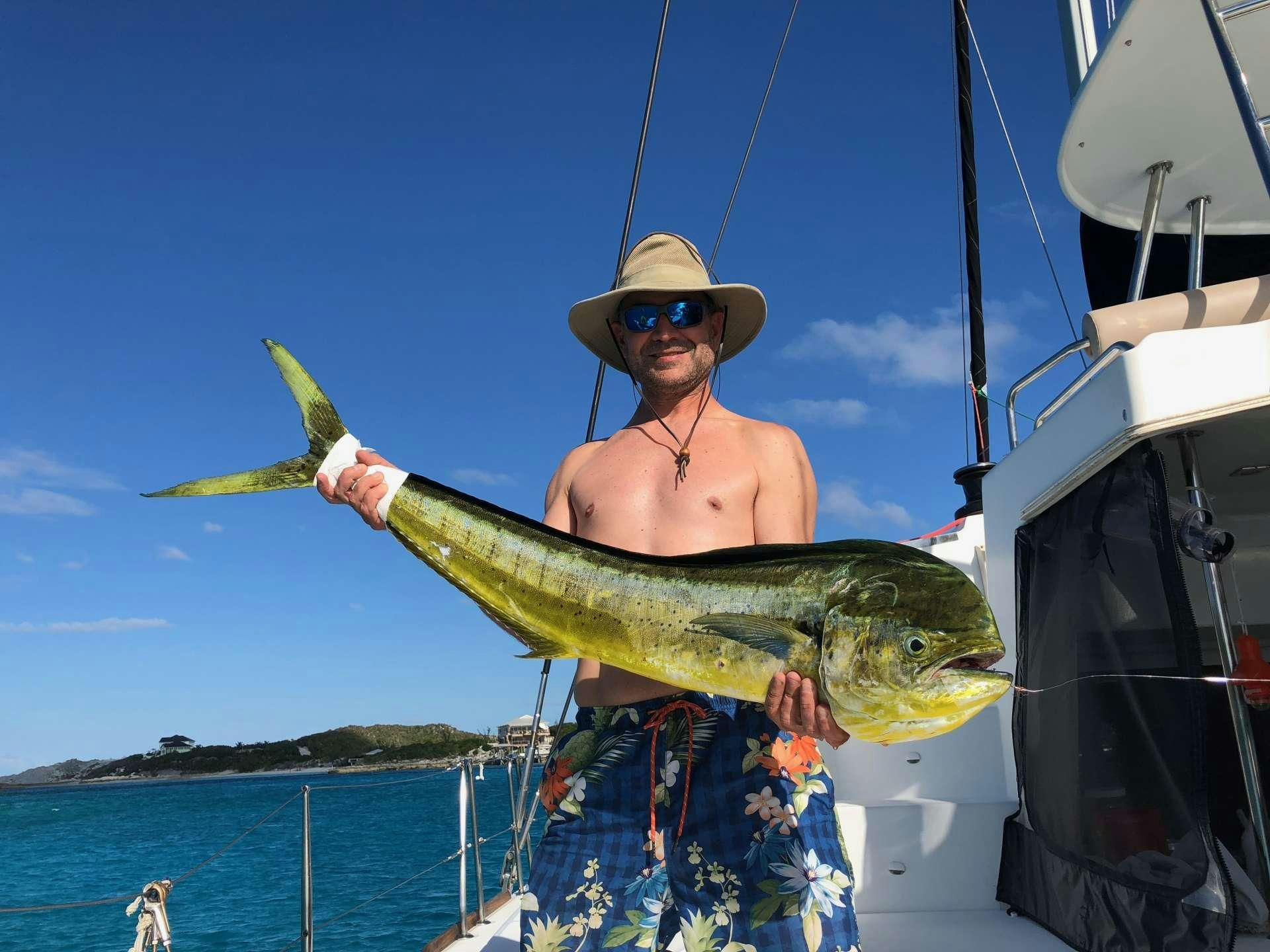 a person holding a fish aboard CATATONIC 500 Yacht for Charter
