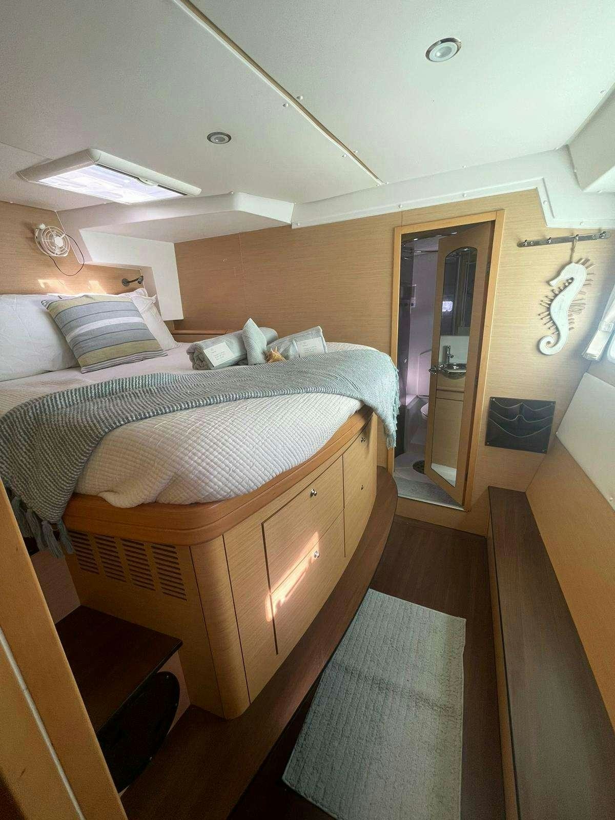 a bedroom with a bed and a door aboard CATATONIC 500 Yacht for Charter