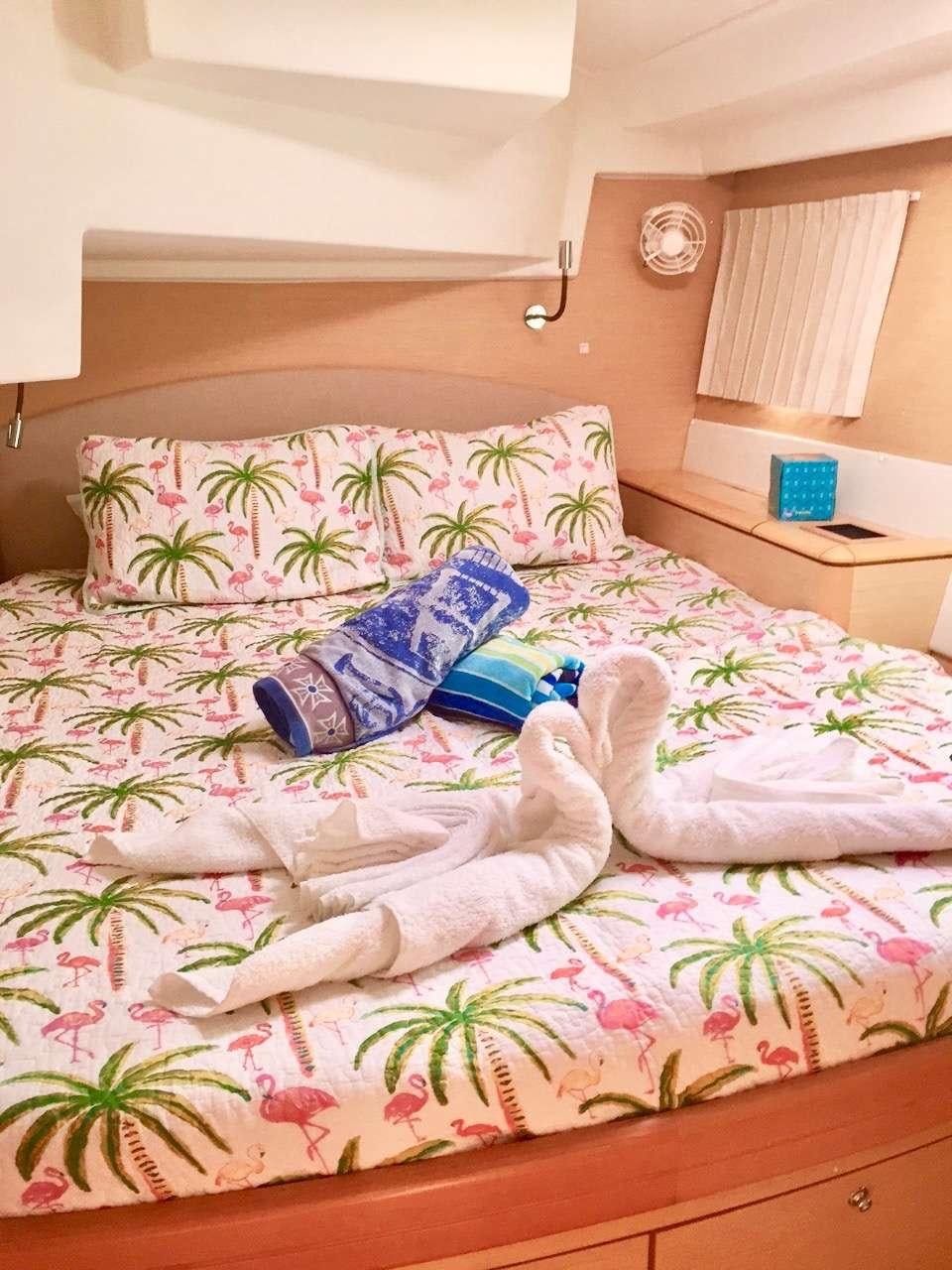 a bed with a blanket and pillows aboard CATATONIC 500 Yacht for Charter