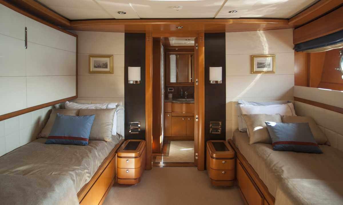 a room with a bed and a door aboard ARIELA Yacht for Charter