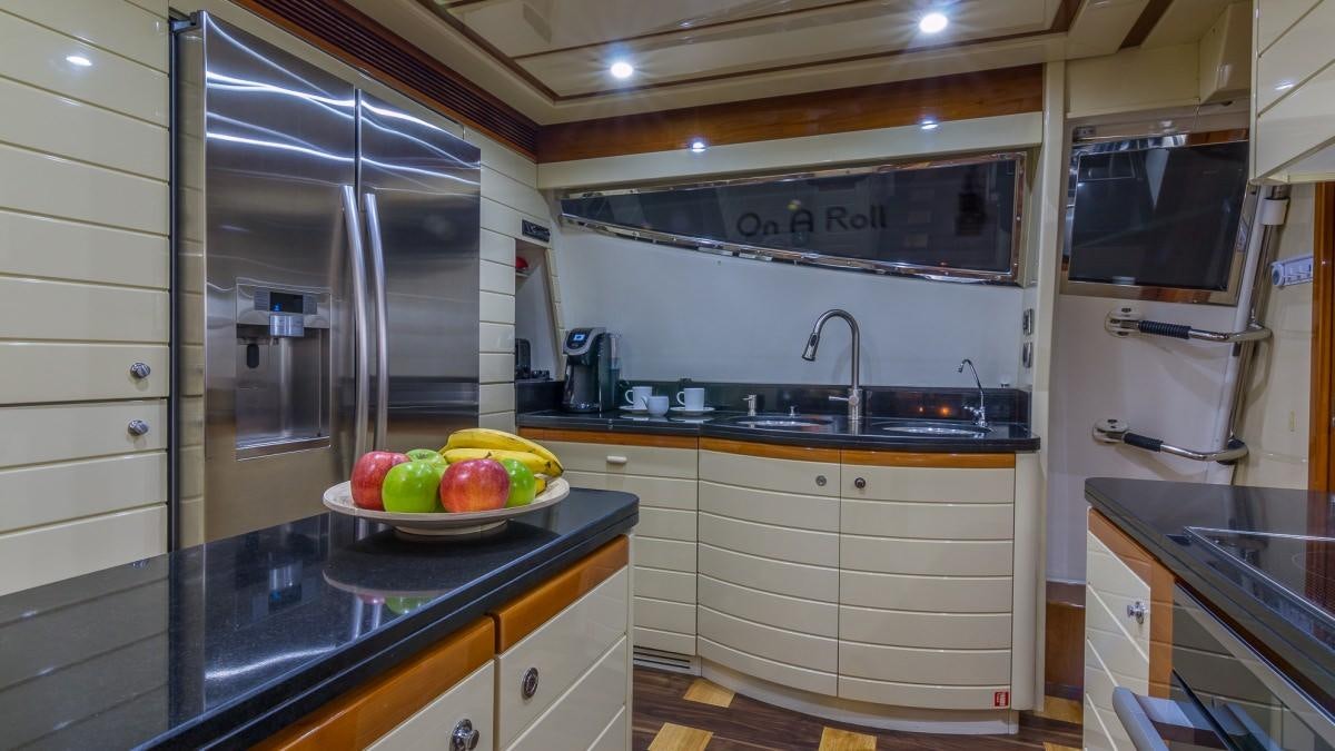 a kitchen with white cabinets aboard CINQUE MARE Yacht for Charter
