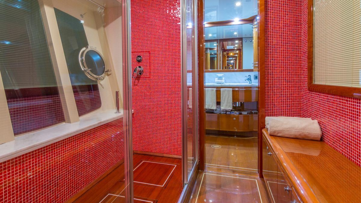 a room with a mirror and a bench aboard CINQUE MARE Yacht for Charter