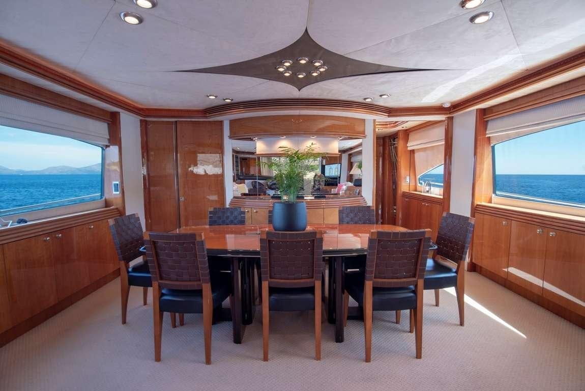 a room with a table and chairs aboard MI ALMA Yacht for Charter