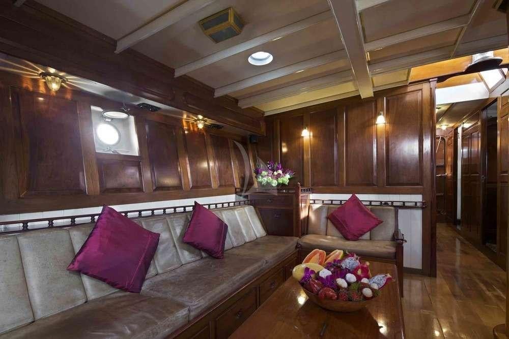 a living room with a couch and a table aboard Sunshine Yacht for Charter