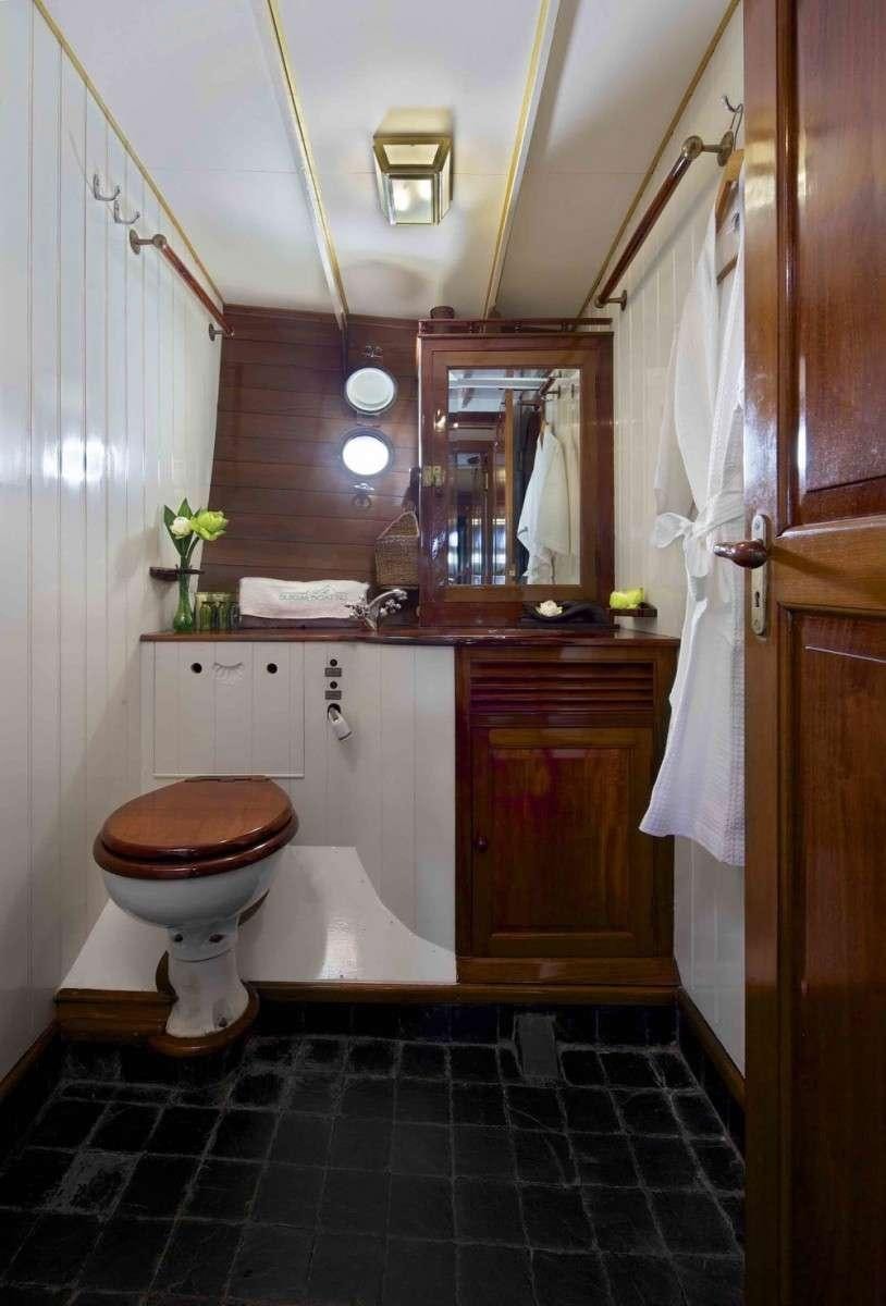 a bathroom with a toilet and a sink aboard Sunshine Yacht for Charter