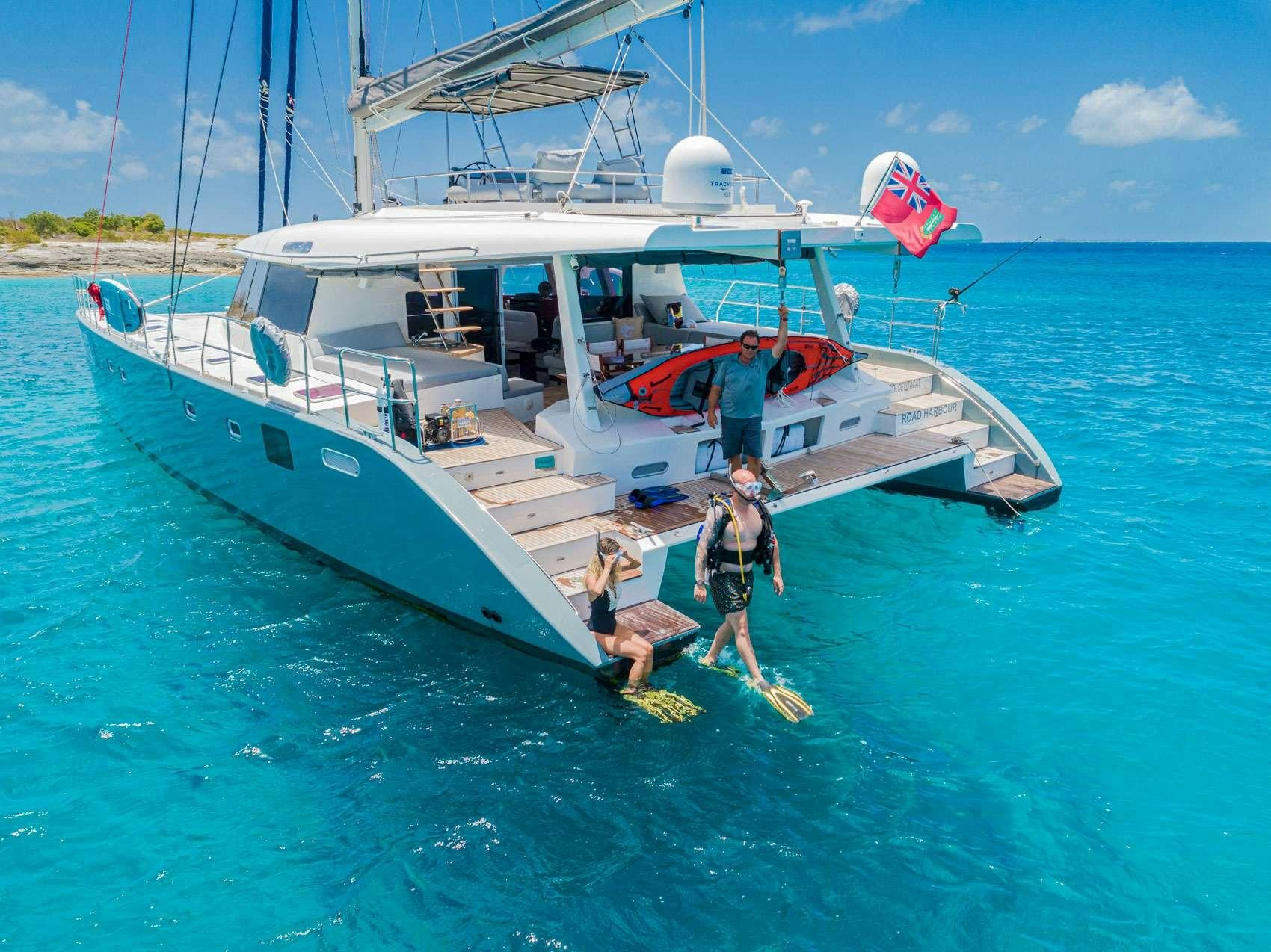 a couple of people on a boat aboard DOLCEVITACAT Yacht for Charter