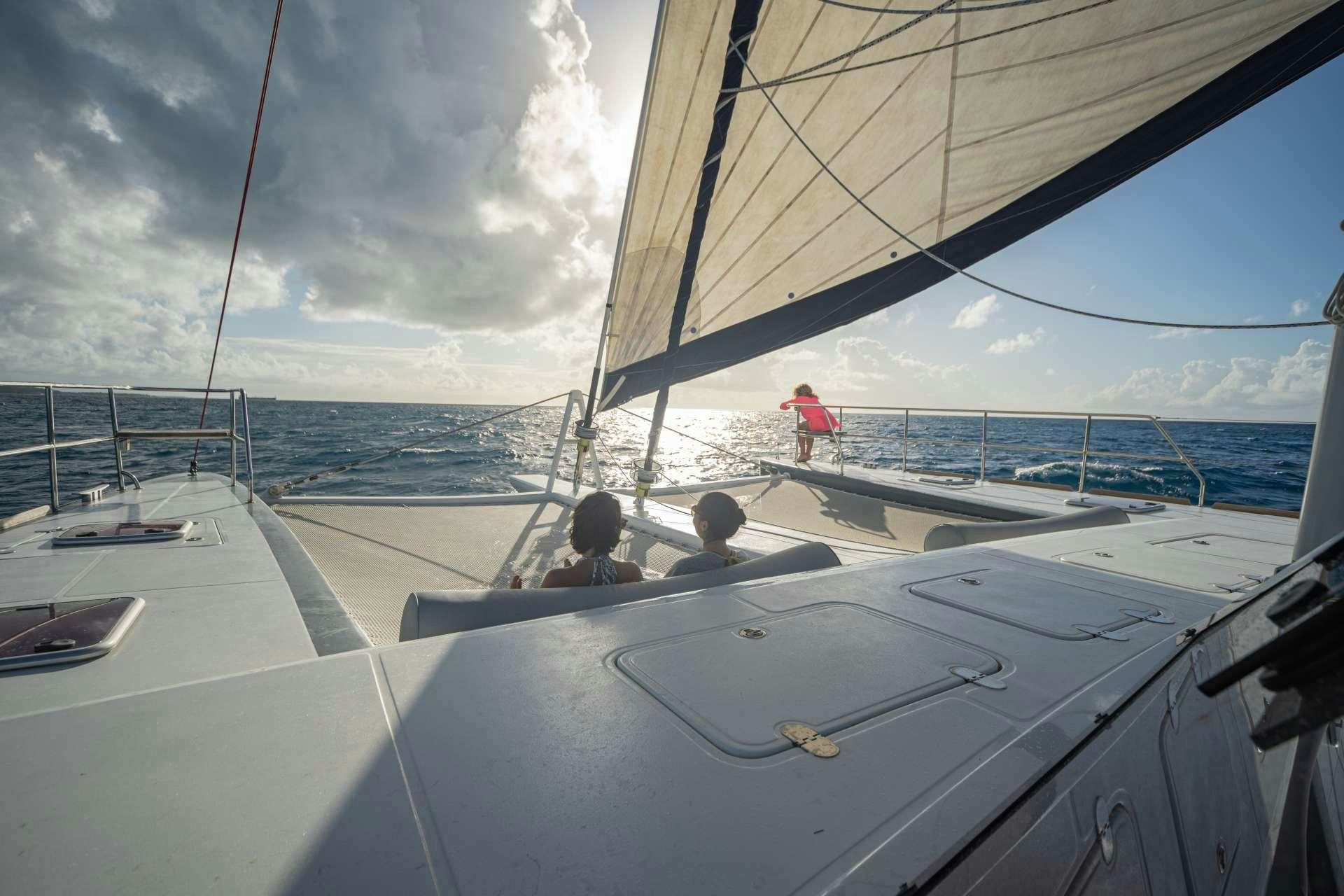 a couple of people on a sailboat aboard DOLCEVITACAT Yacht for Charter