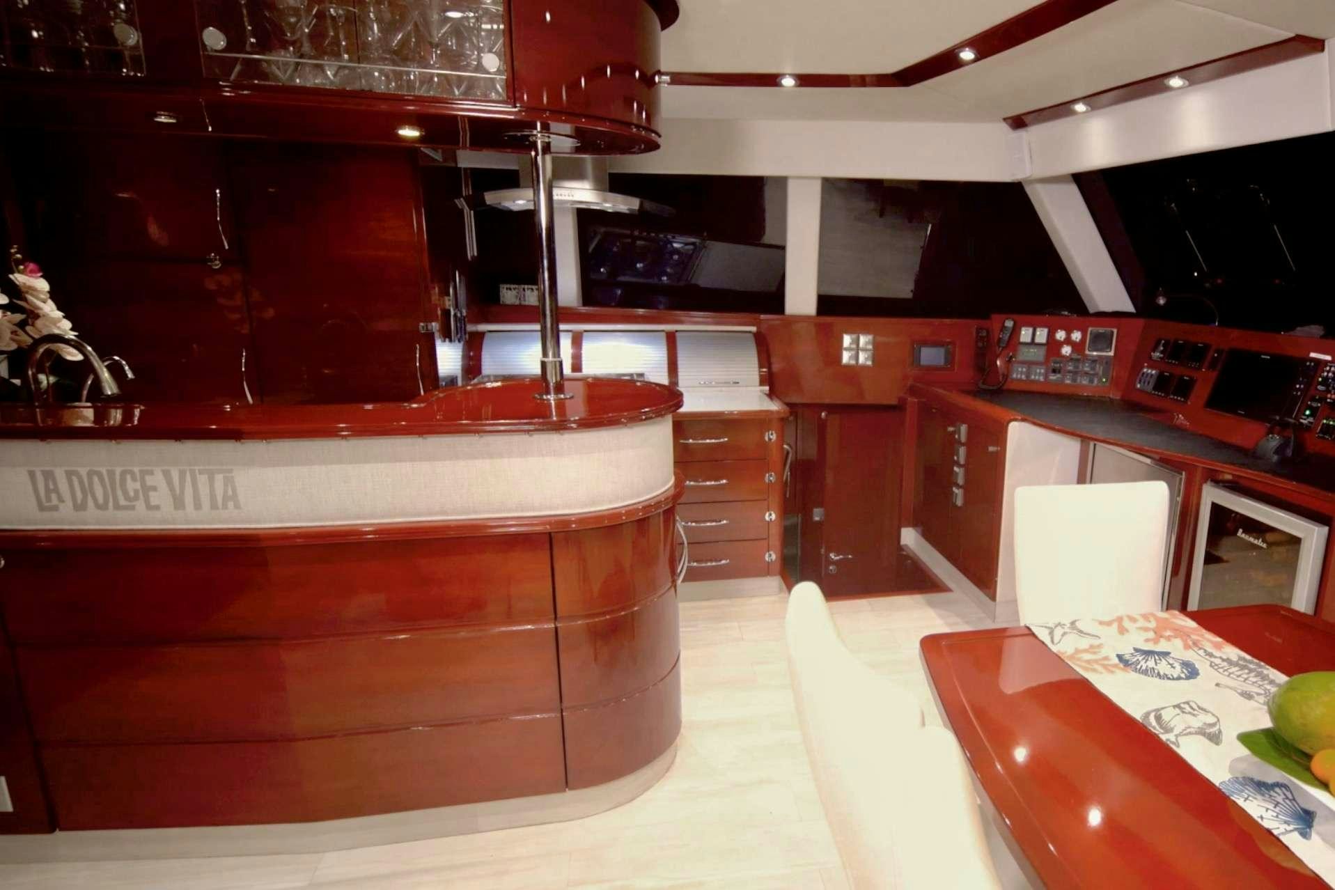 a room with a table and chairs aboard DOLCEVITACAT Yacht for Charter