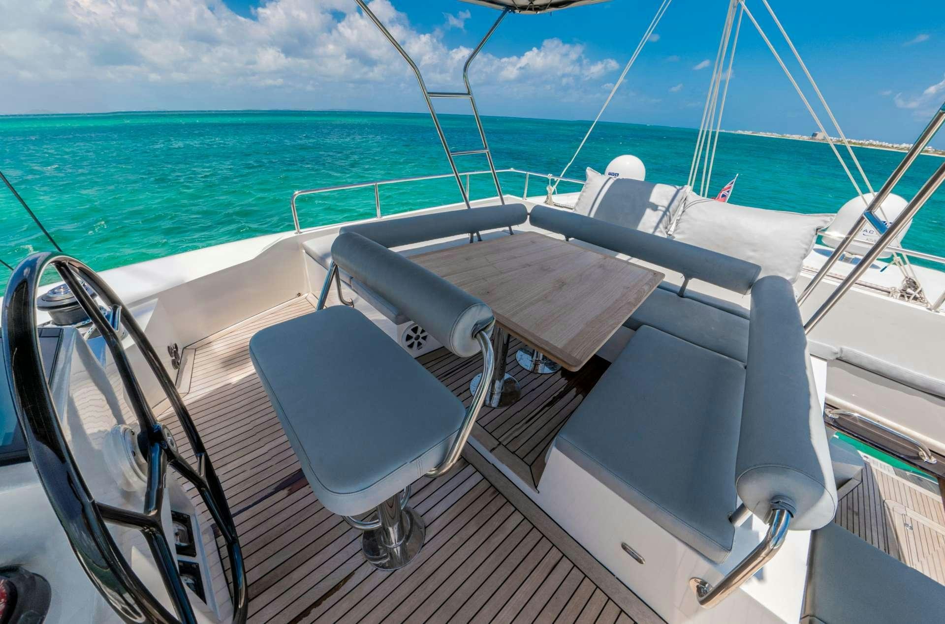 a boat with a chair on it aboard DOLCEVITACAT Yacht for Charter