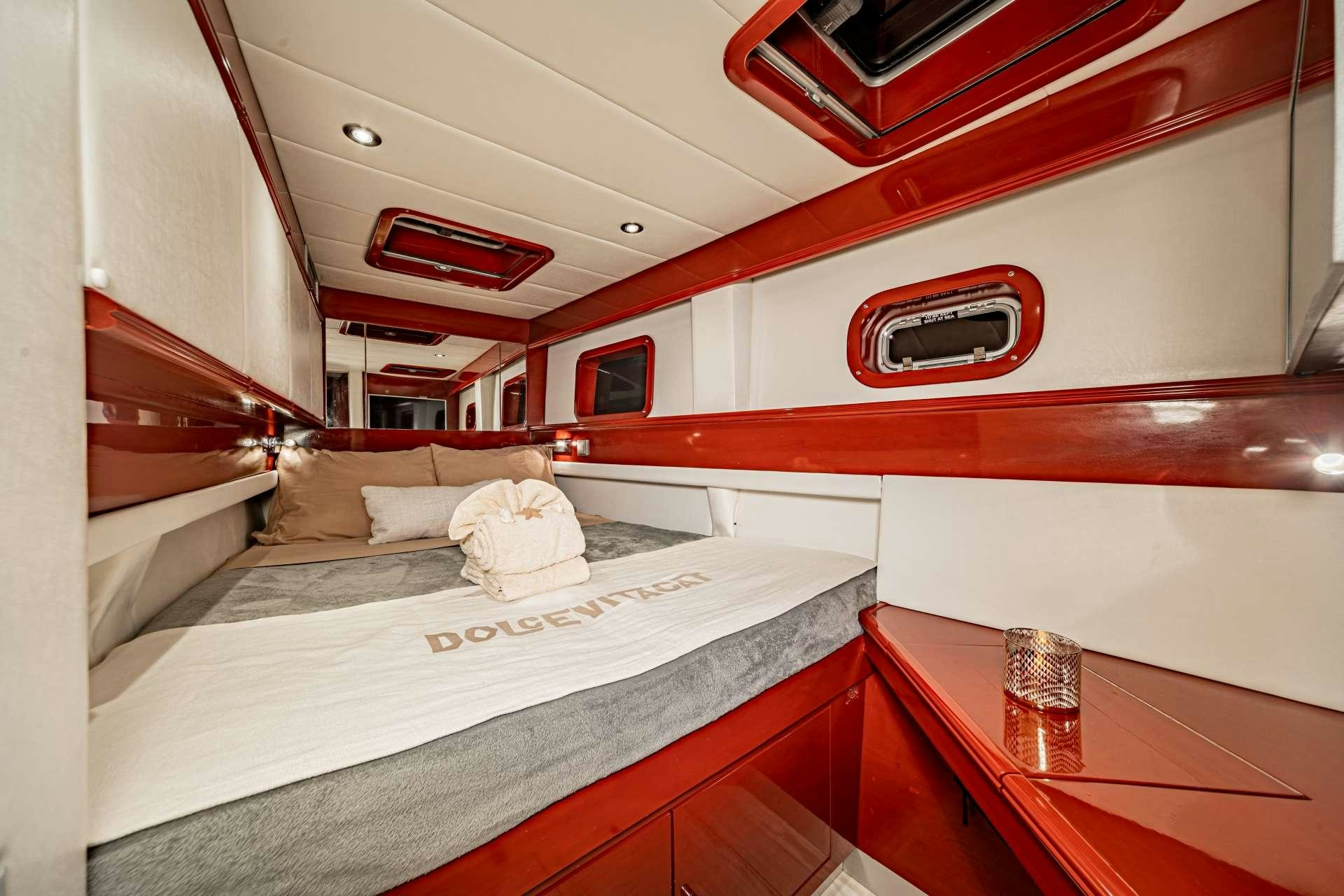 a room with a bed and a window aboard DOLCEVITACAT Yacht for Charter