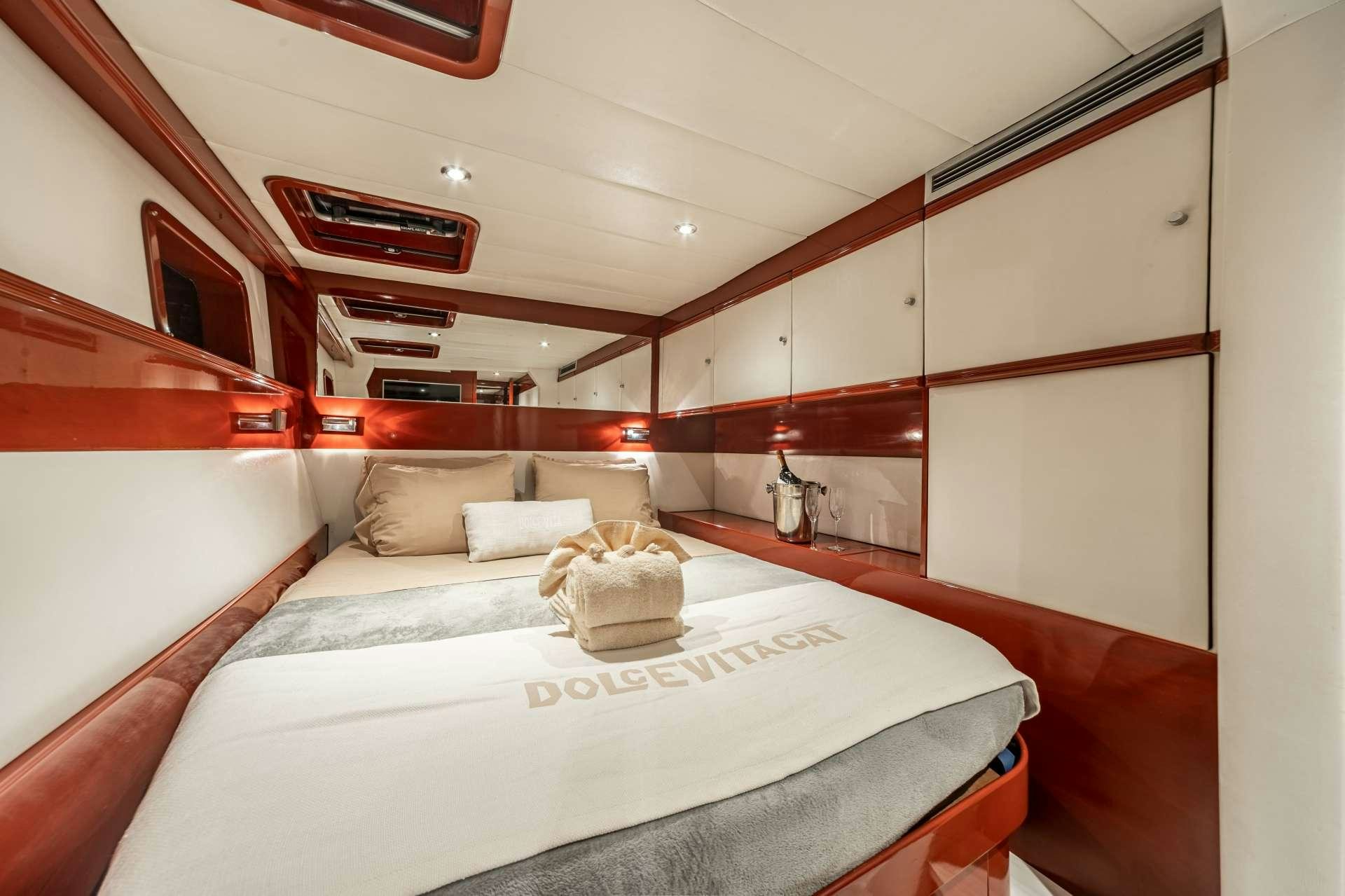a room with a bed and a couch aboard DOLCEVITACAT Yacht for Charter