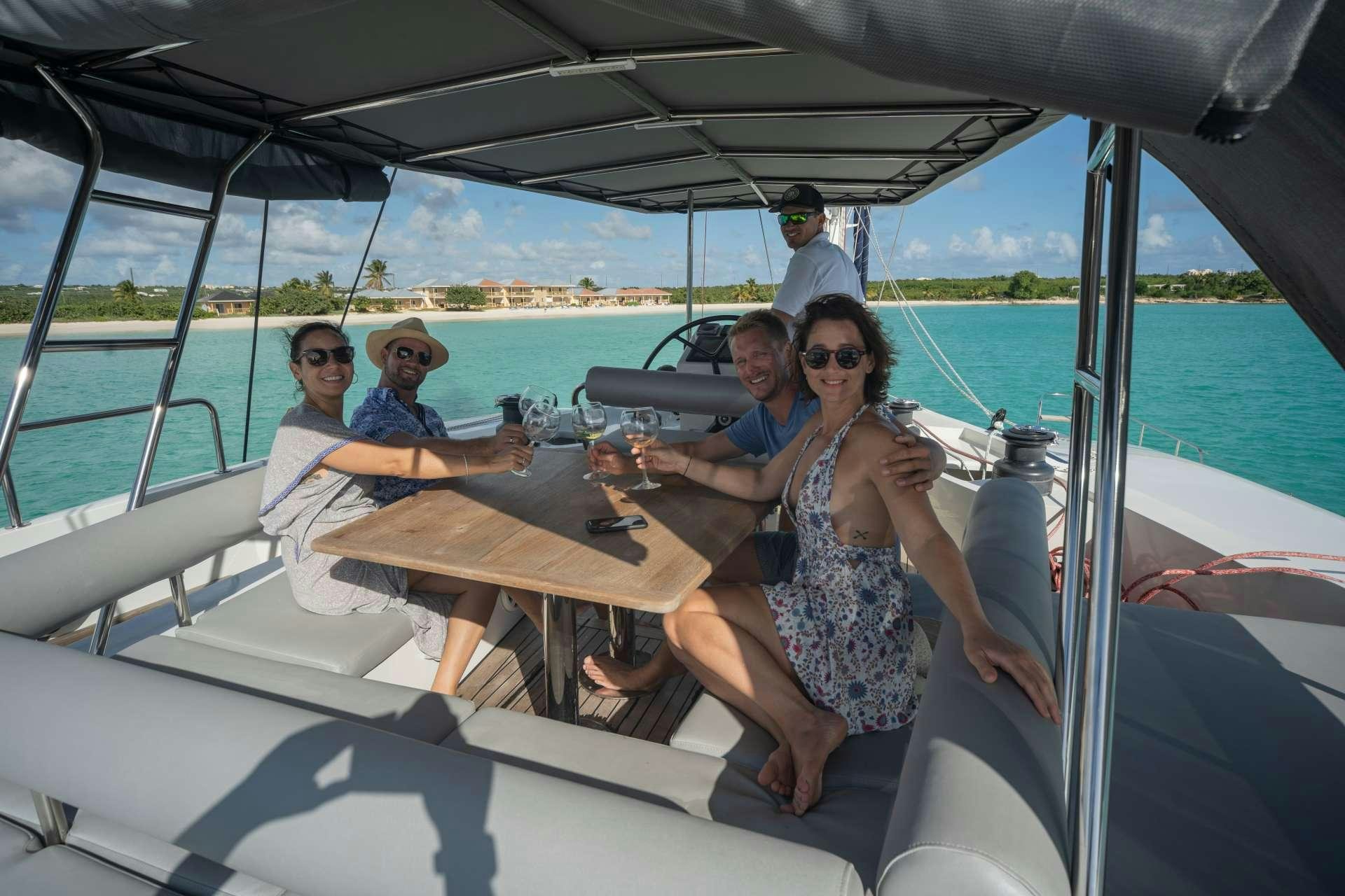 a group of people sitting in a boat aboard DOLCEVITACAT Yacht for Charter