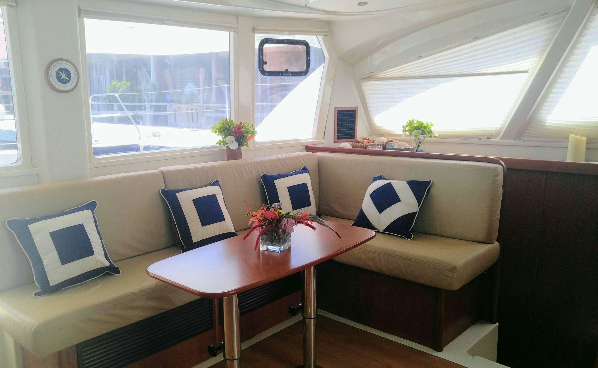 a living room with a couch and a table aboard Flojo Yacht for Charter