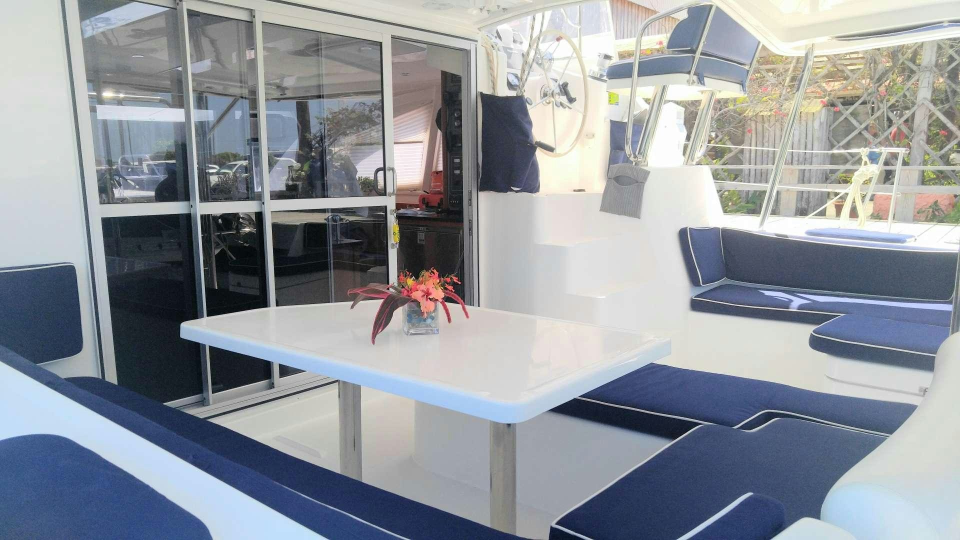 a white table with a red flower on it aboard Flojo Yacht for Charter