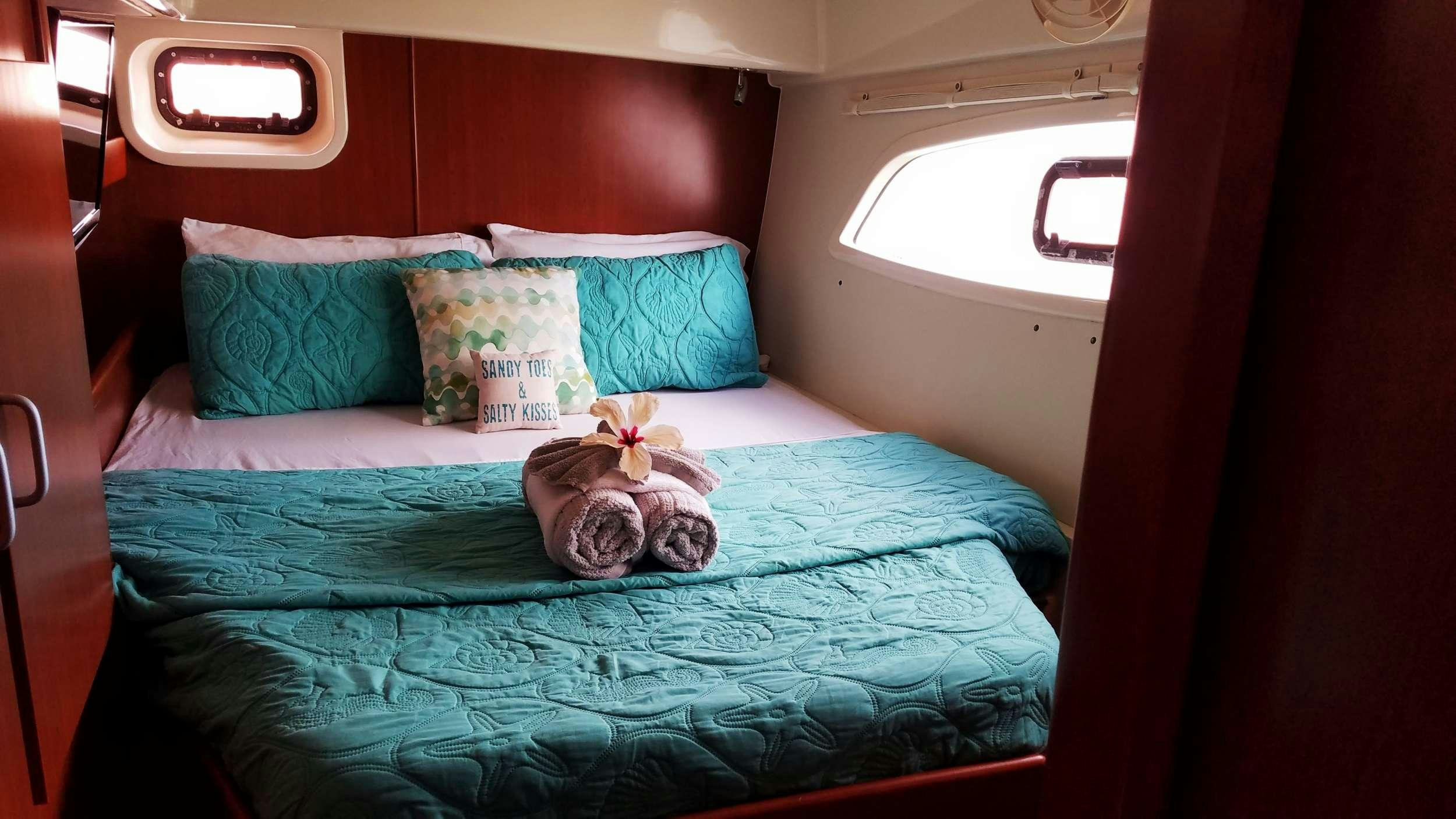 a teddy bear on a bed aboard Flojo Yacht for Charter