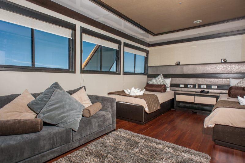 a living room with a couch and a tv aboard GALAPAGOS SEA STAR JOURNEY Yacht for Charter