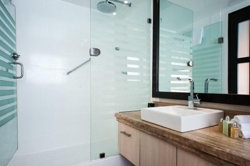 a bathroom with a glass shower aboard GALAPAGOS SEA STAR JOURNEY Yacht for Charter