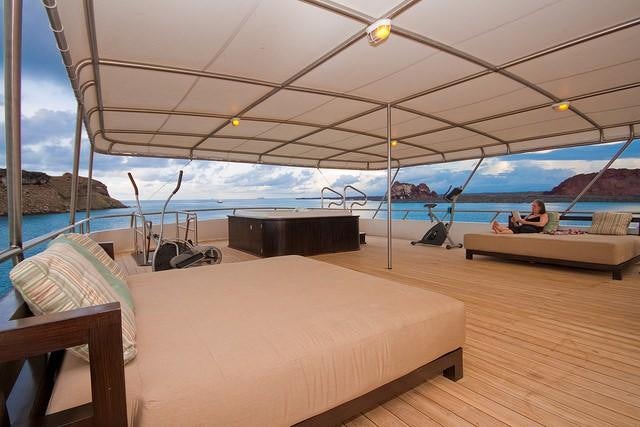 a tent with a person sitting on it aboard GALAPAGOS SEA STAR JOURNEY Yacht for Charter