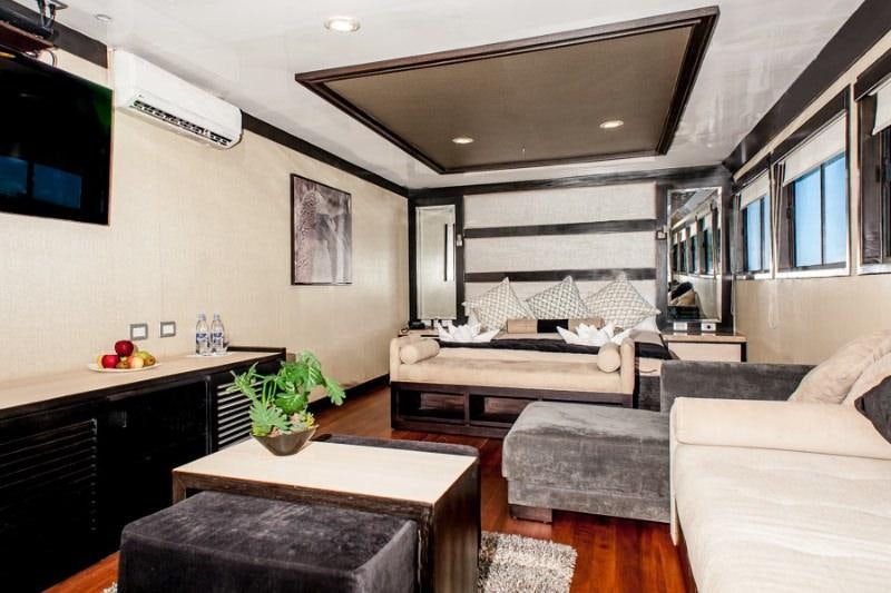 a living room with a couch and a table aboard GALAPAGOS SEA STAR JOURNEY Yacht for Charter