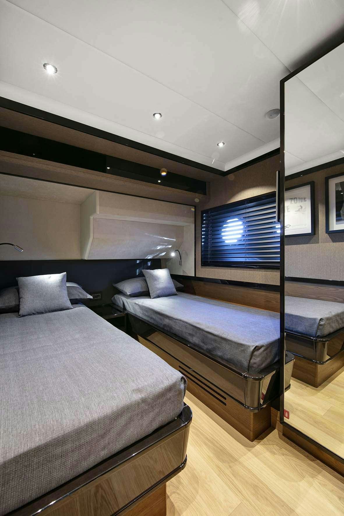 a room with two beds aboard ENIGMA Yacht for Charter