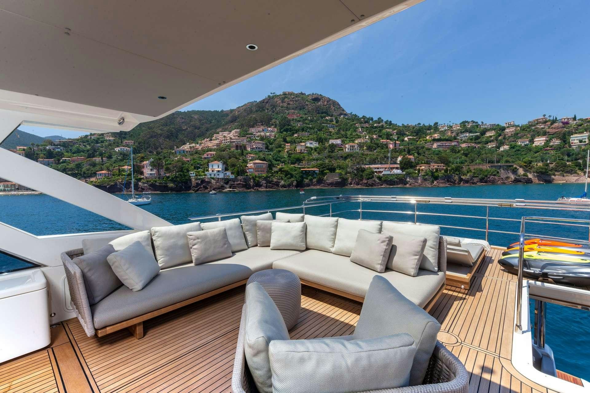 a living room with a large balcony overlooking a city aboard ENIGMA Yacht for Charter
