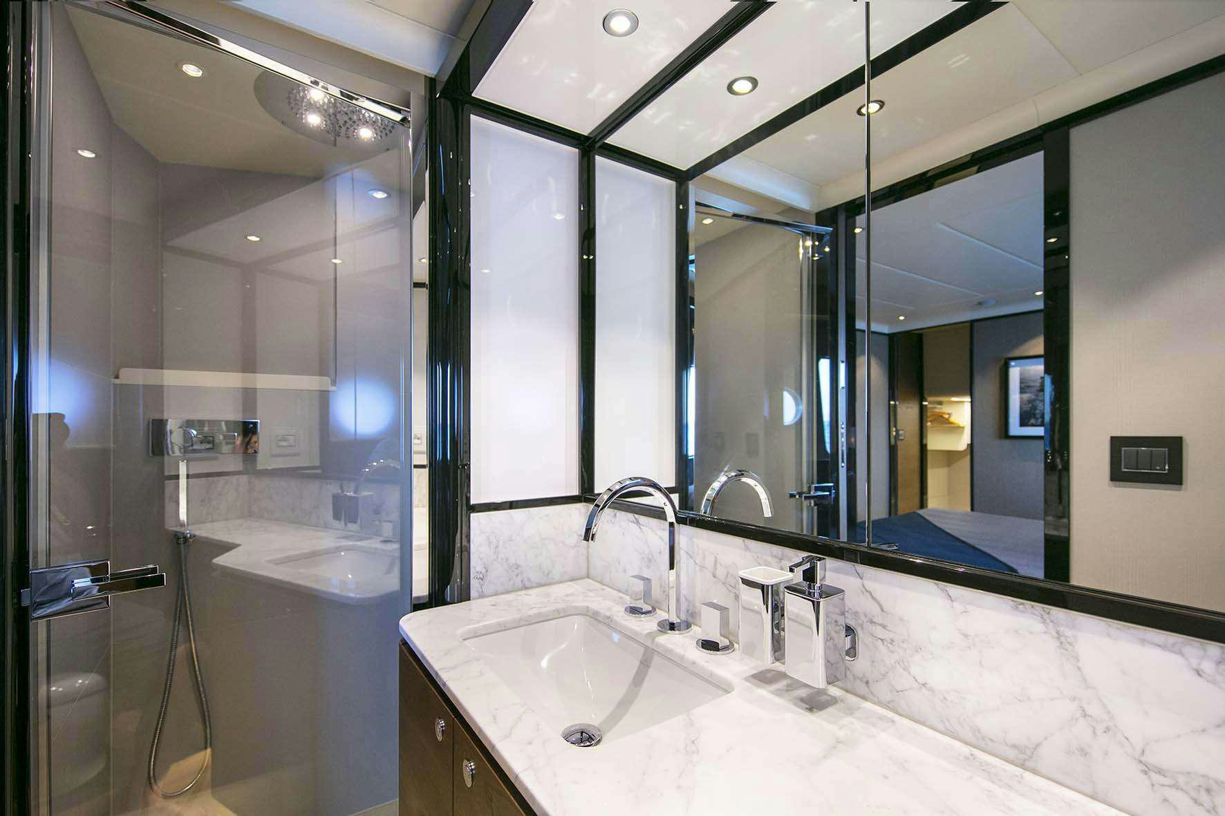 a bathroom with a large mirror aboard ENIGMA Yacht for Charter