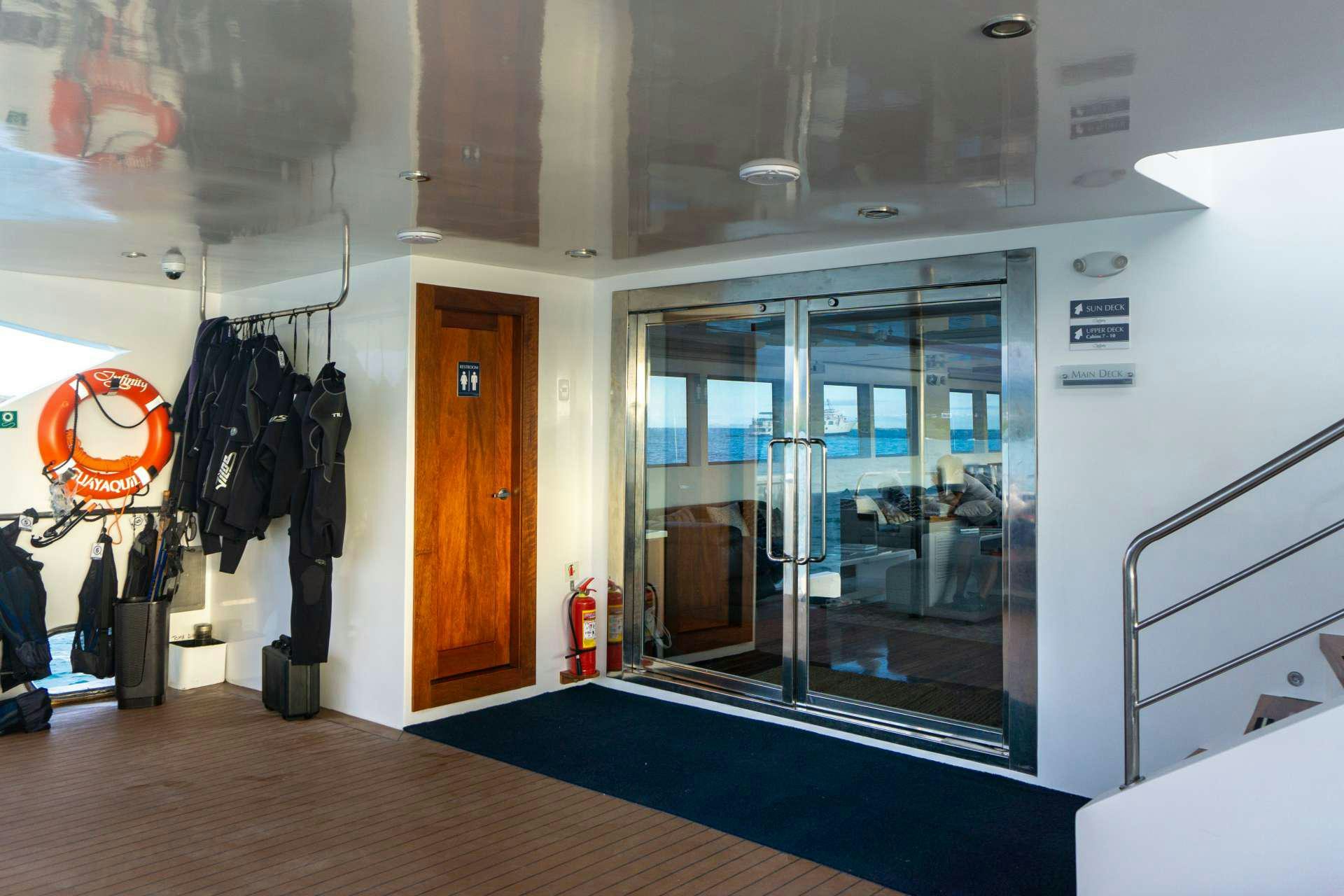 a room with a glass door and a mirror aboard INFINITY Yacht for Charter
