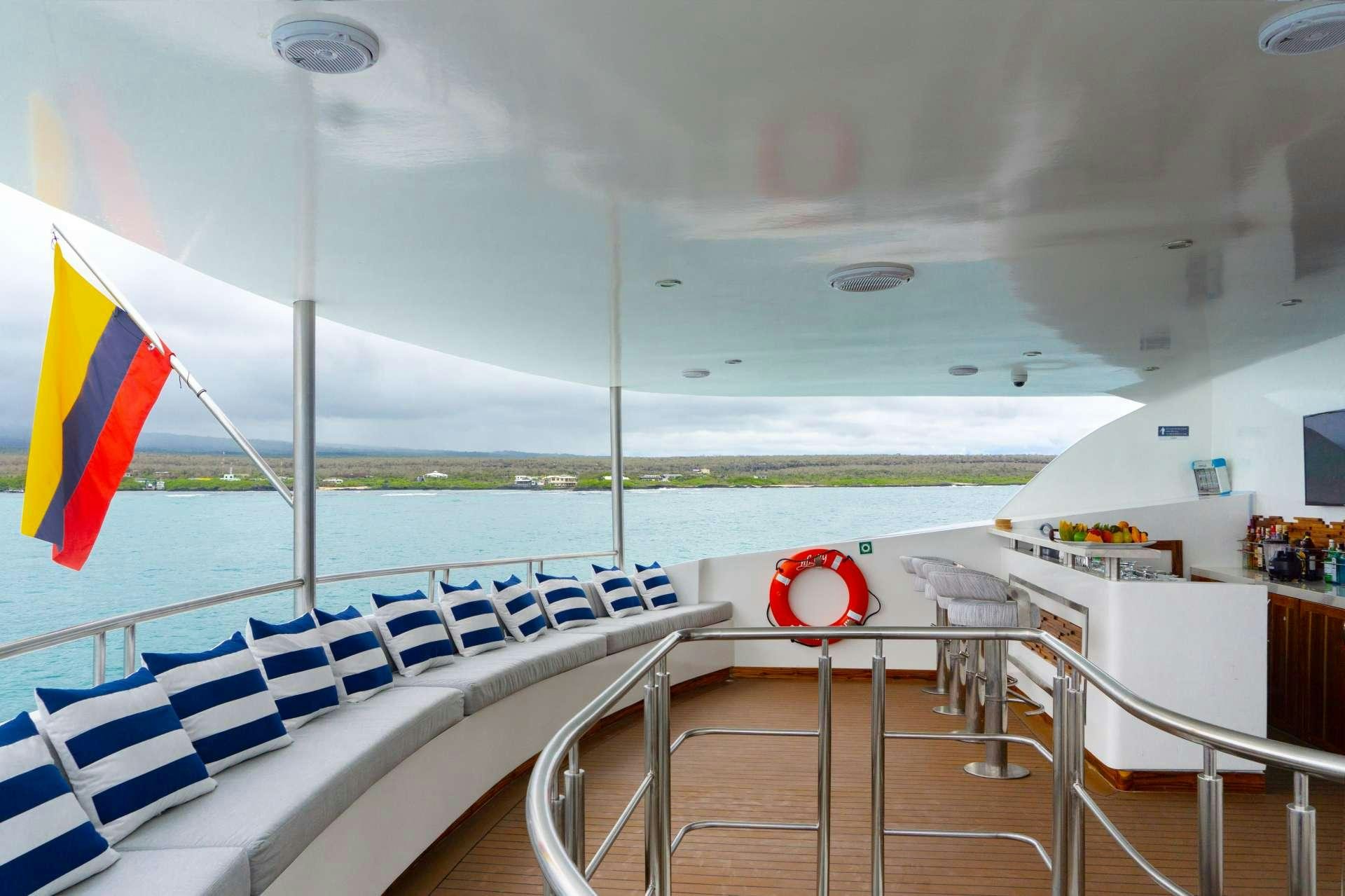 a boat with a flag on the deck aboard INFINITY Yacht for Charter