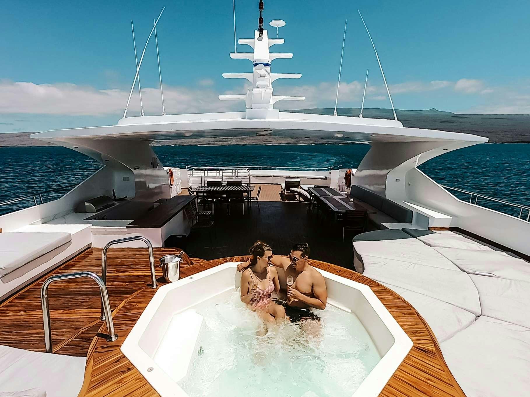 a group of people sitting on a boat in the water aboard INFINITY Yacht for Charter