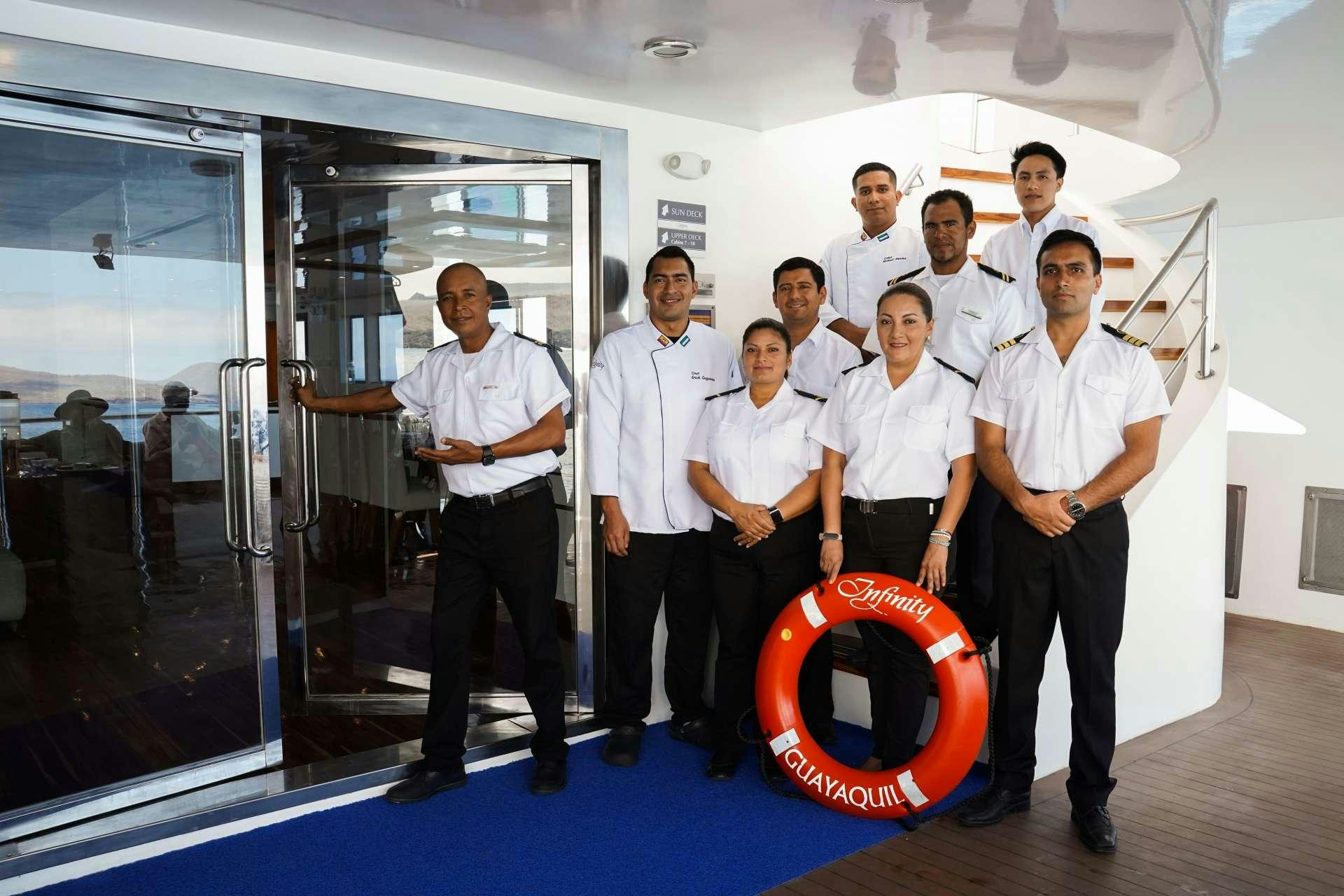 a group of people posing for a photo aboard INFINITY Yacht for Charter