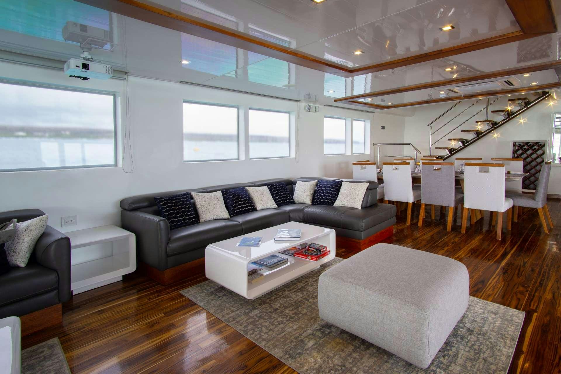 a living room with a couch and a table aboard INFINITY Yacht for Charter