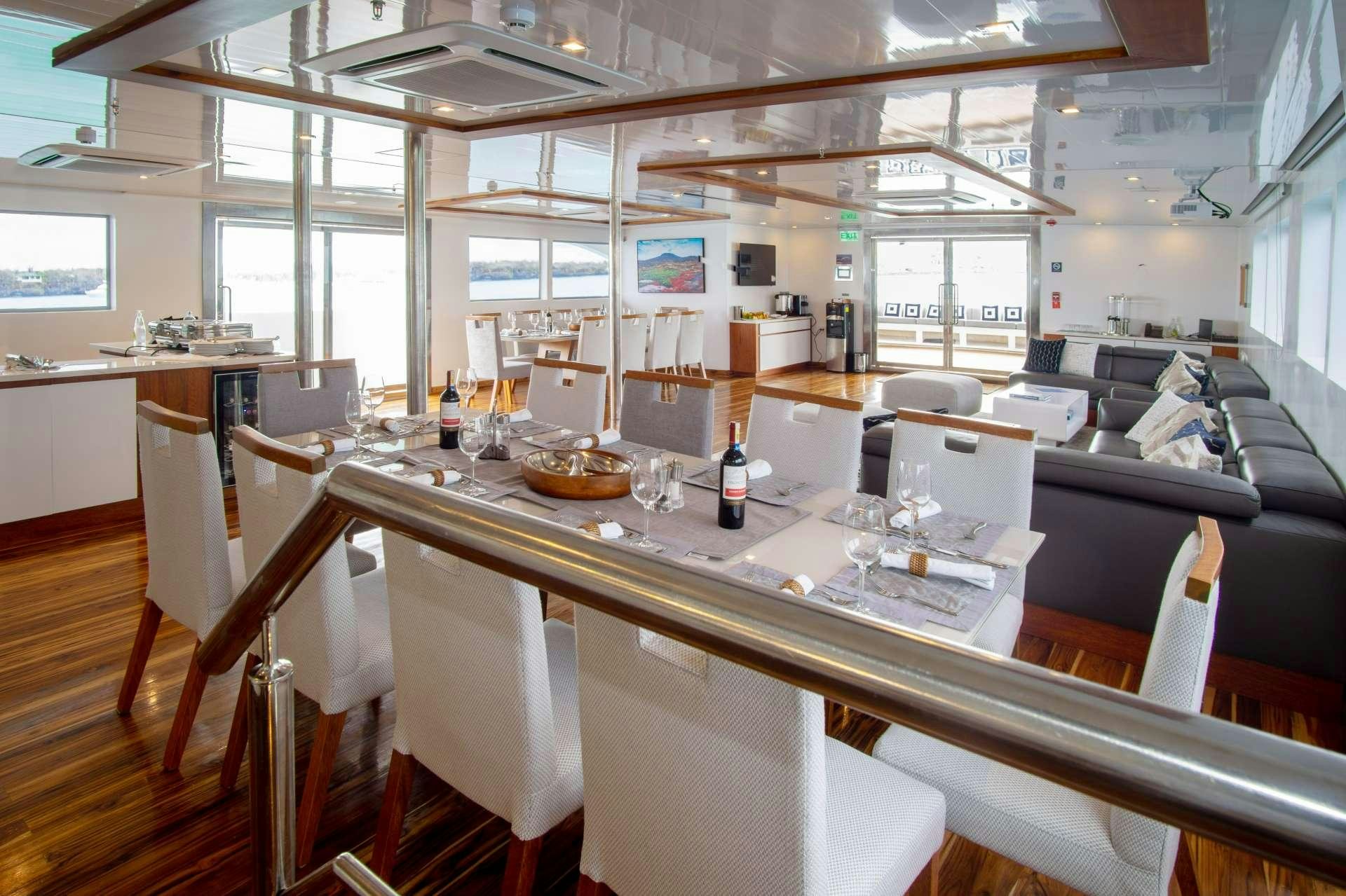 a large table with wine glasses aboard INFINITY Yacht for Charter