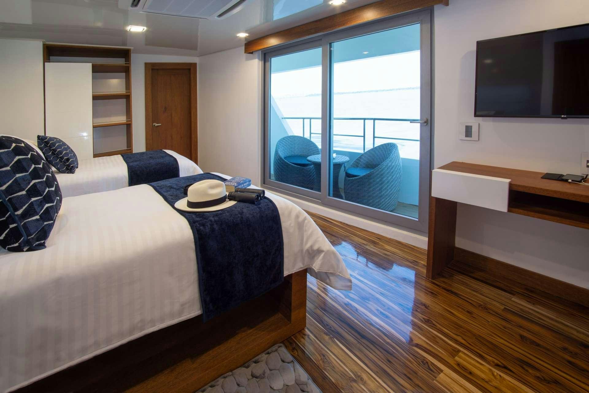 a bedroom with a bed and a tv aboard INFINITY Yacht for Charter