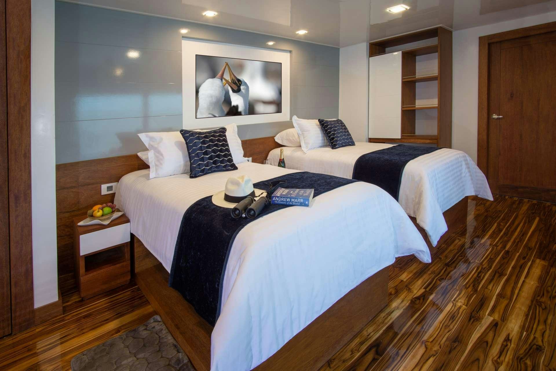 a bedroom with a bed and a table aboard INFINITY Yacht for Charter