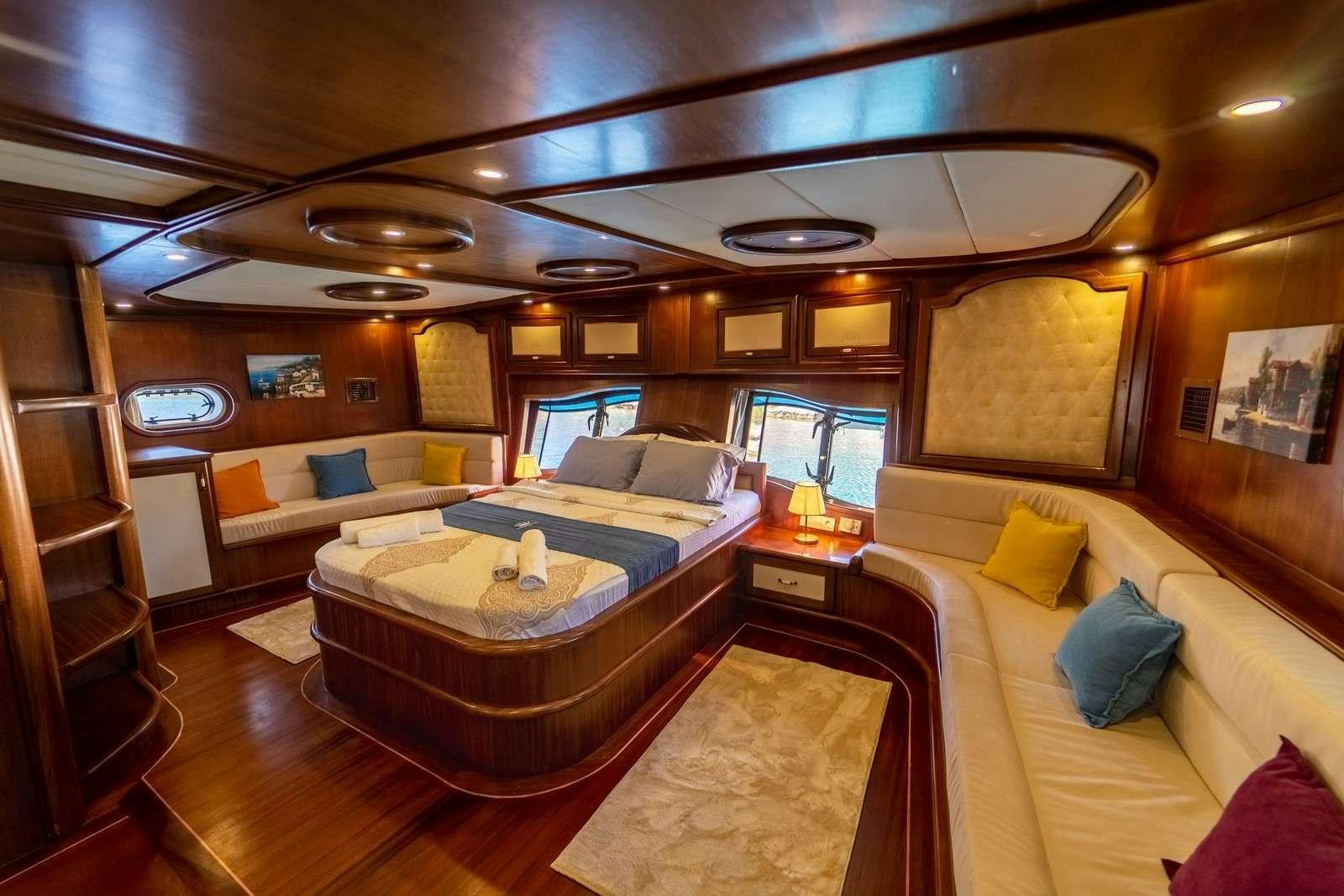a room with a bed and a couch aboard PRENSES BUGCE Yacht for Charter