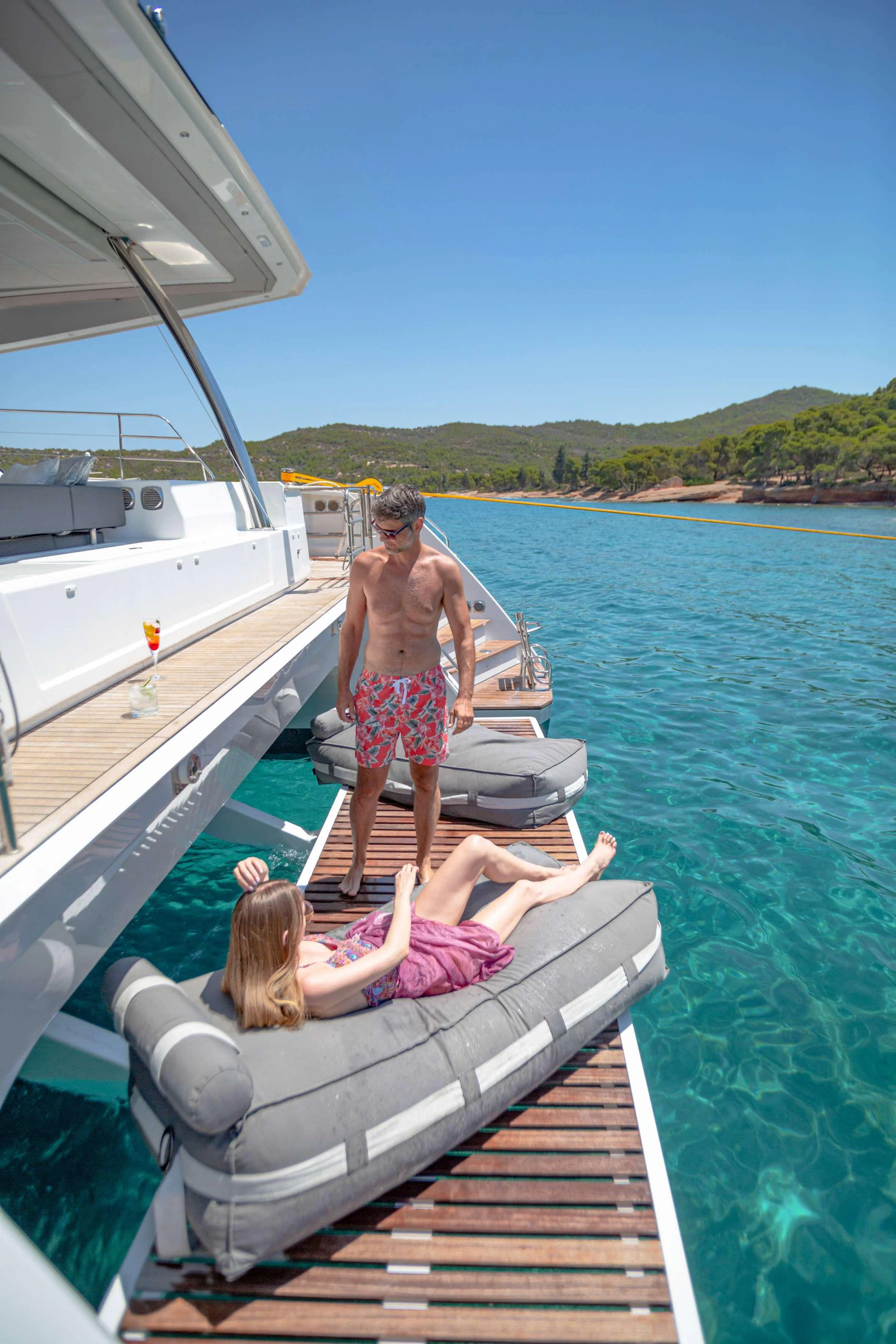 a man and woman on a boat aboard CHRISTAL MIO Yacht for Charter