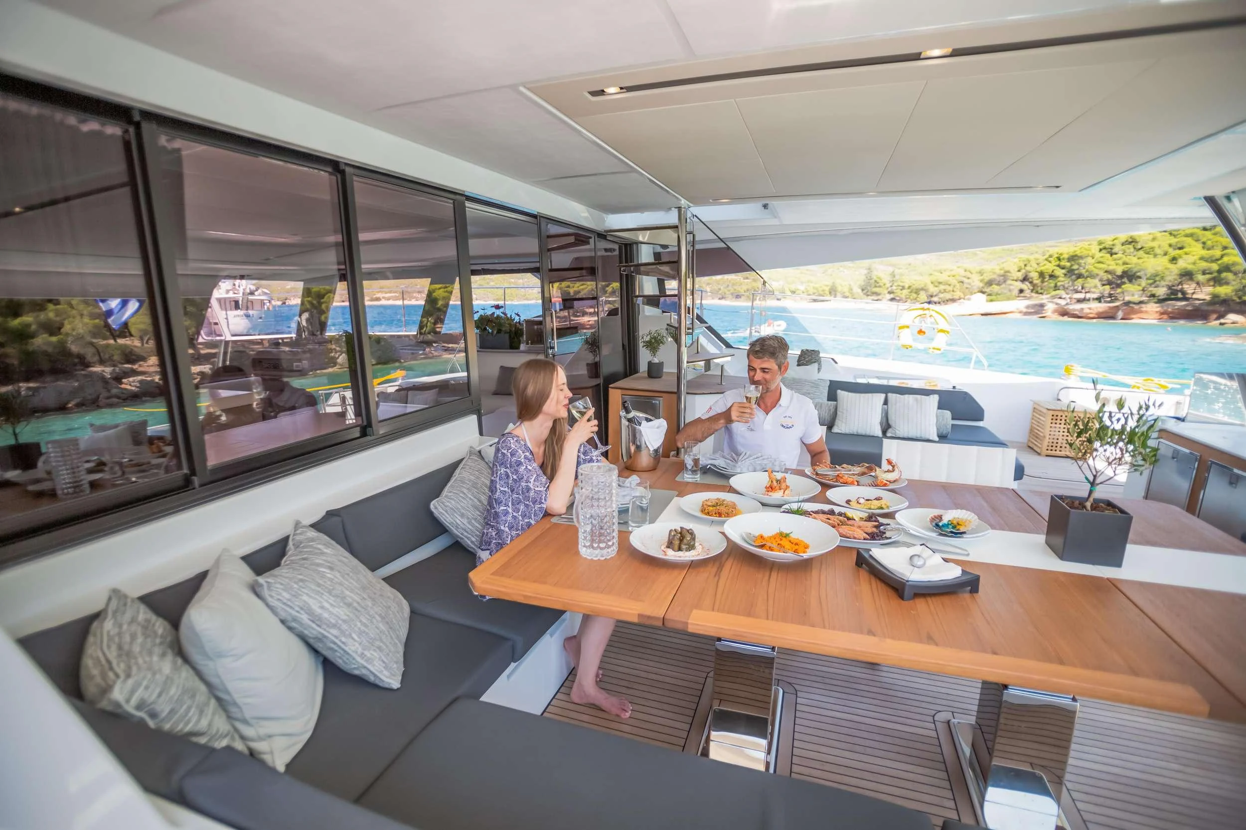 a couple sitting at a table in a restaurant aboard CHRISTAL MIO Yacht for Charter