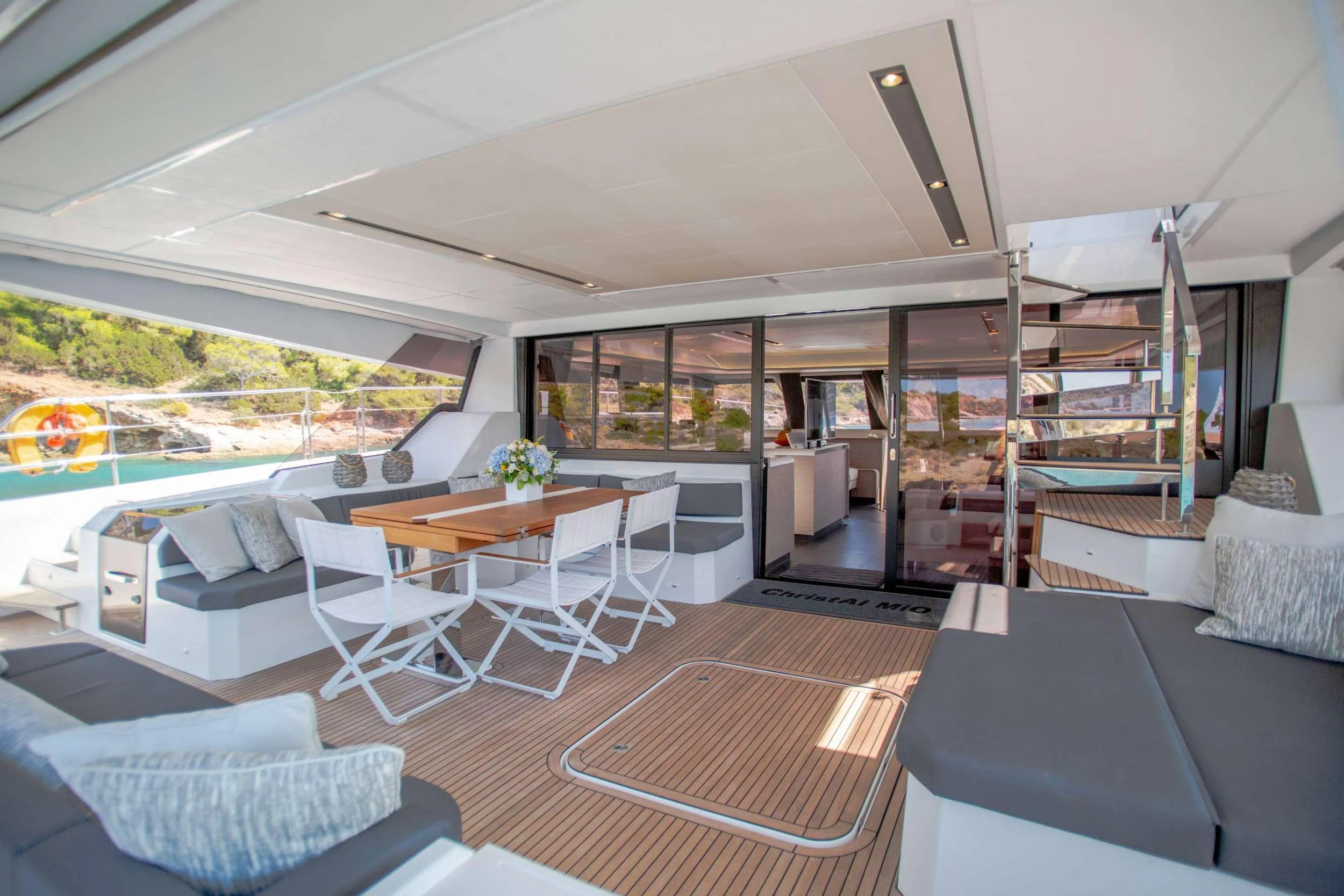 a room with a table chairs and a bed aboard CHRISTAL MIO Yacht for Charter