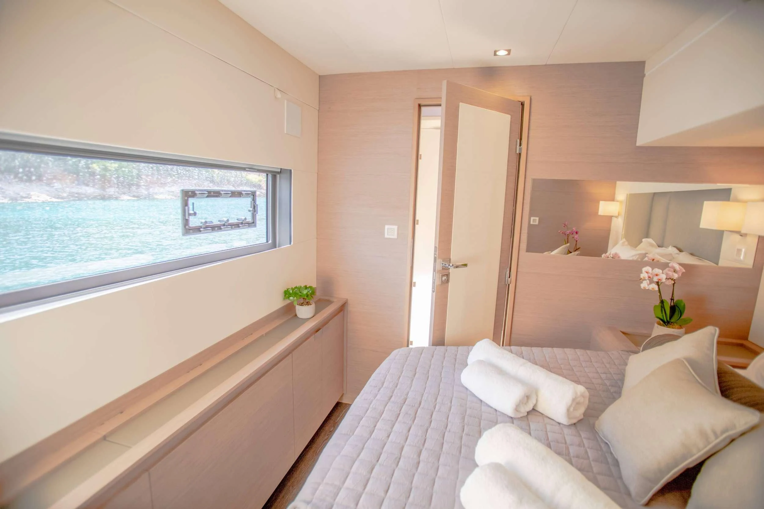 a room with a bed and a window aboard CHRISTAL MIO Yacht for Charter