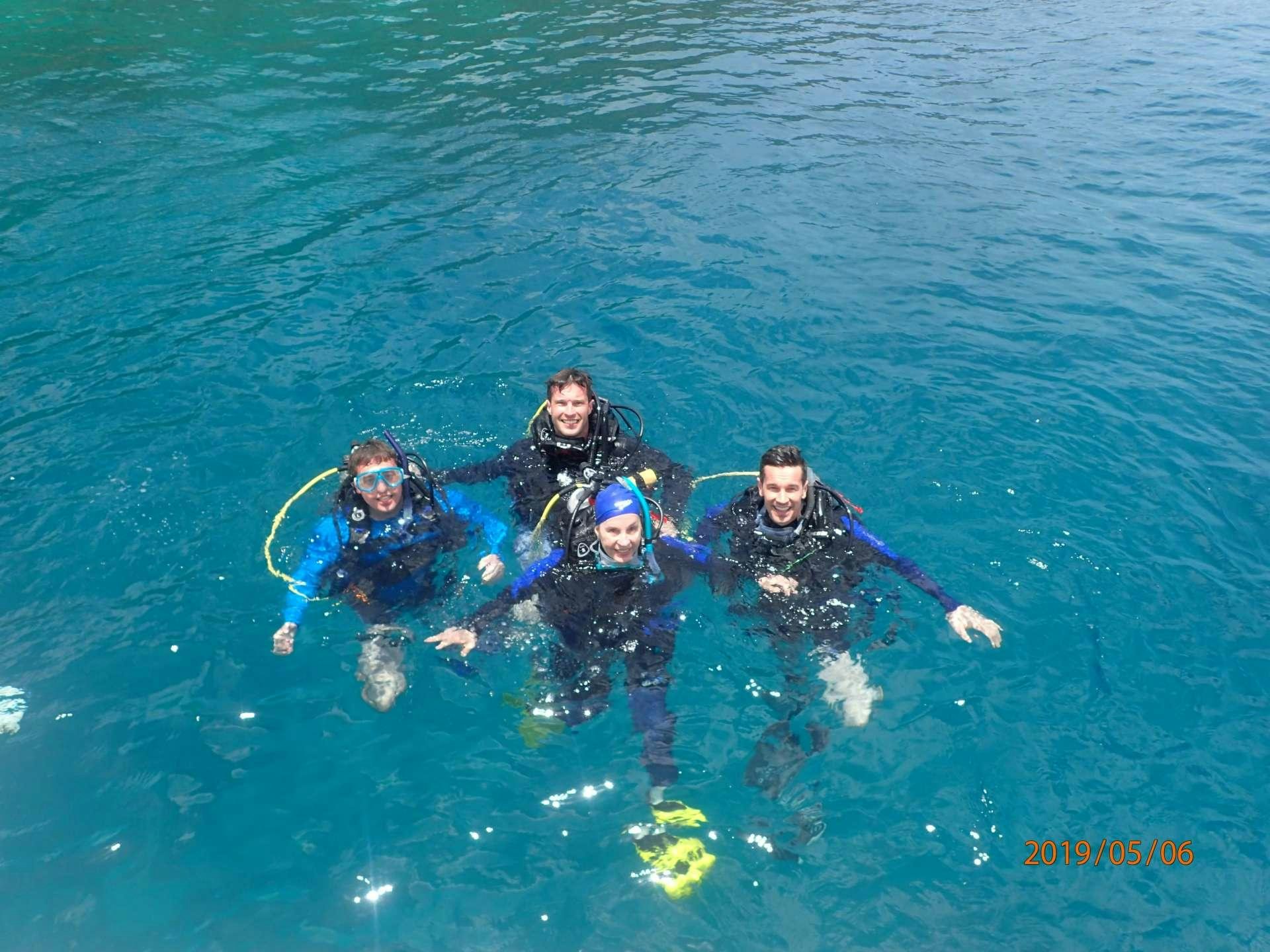 a group of people in a body of water aboard NUTMEG Yacht for Charter