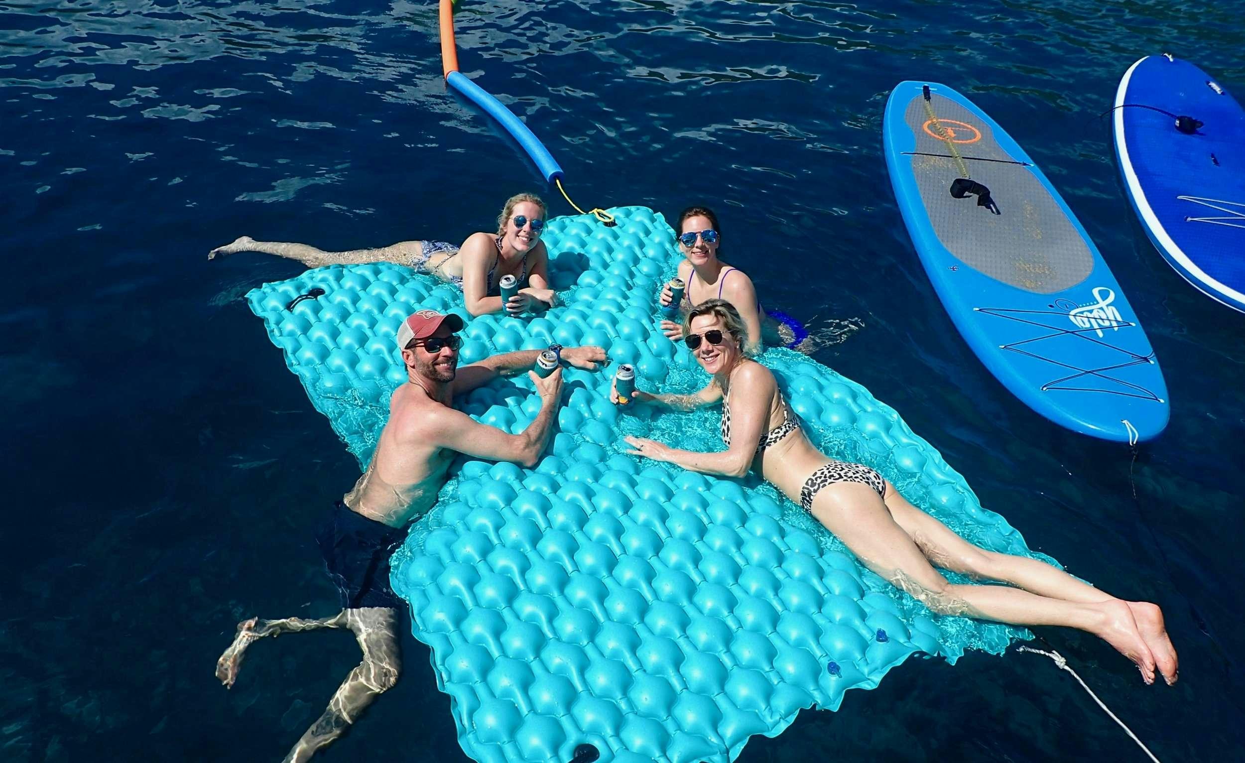 a group of people in a pool aboard NUTMEG Yacht for Charter