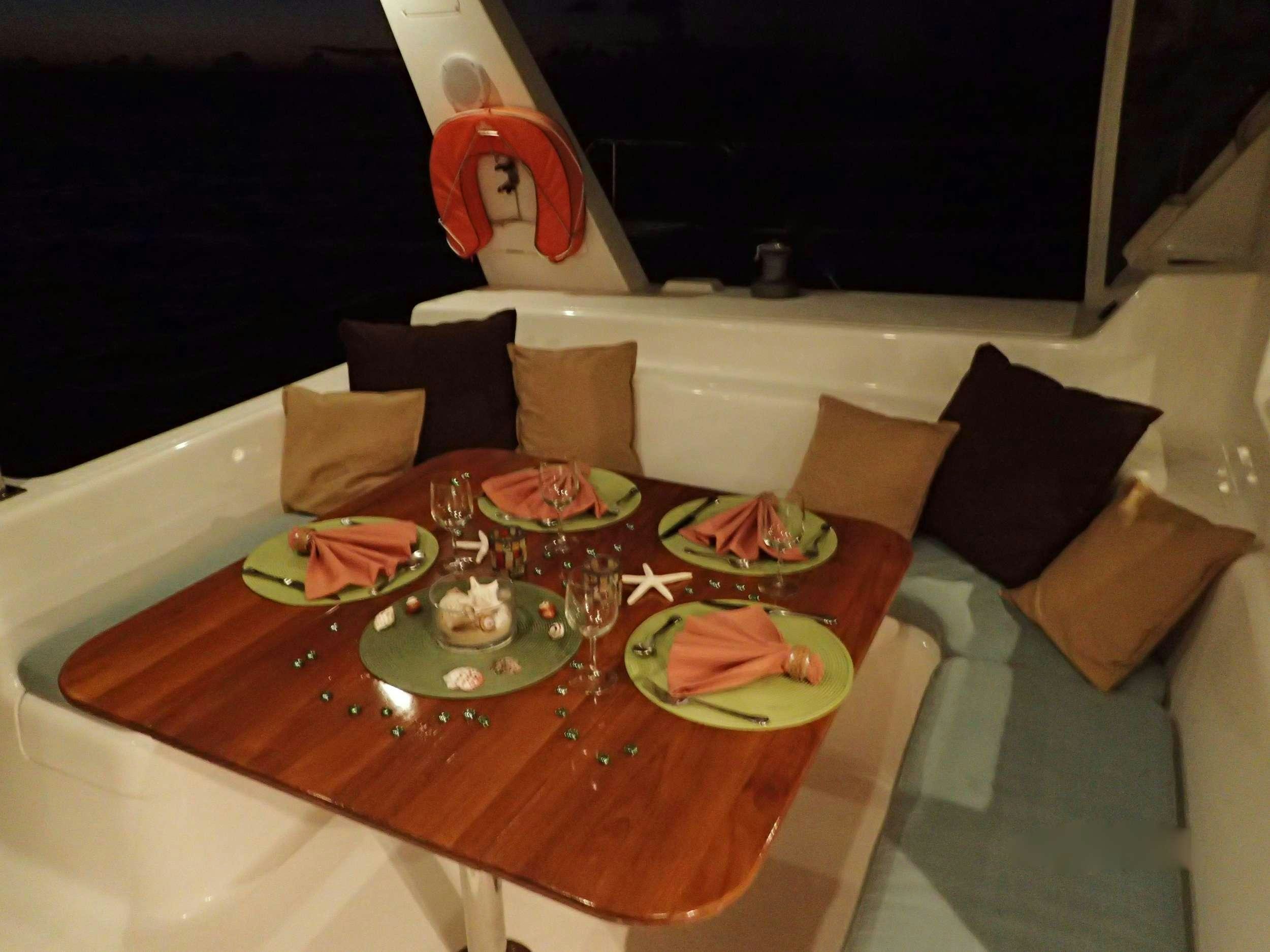 a table with food and drinks on it aboard NUTMEG Yacht for Charter