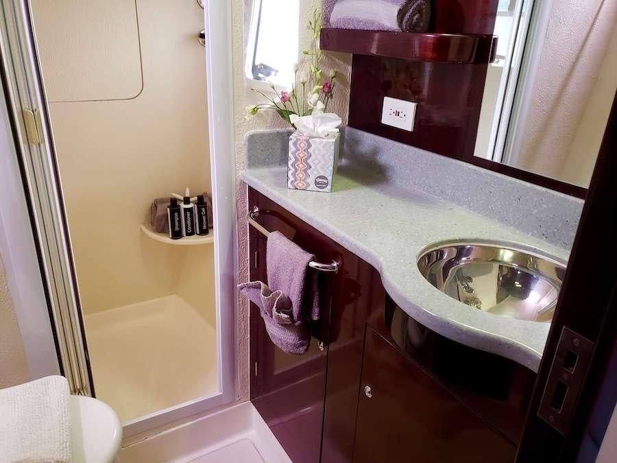a bathroom with a sink and mirror aboard NUTMEG Yacht for Charter