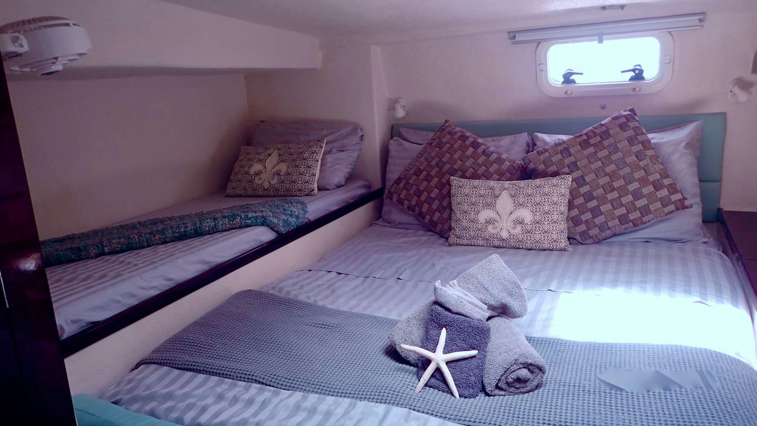 a couple of beds in a room aboard NUTMEG Yacht for Charter