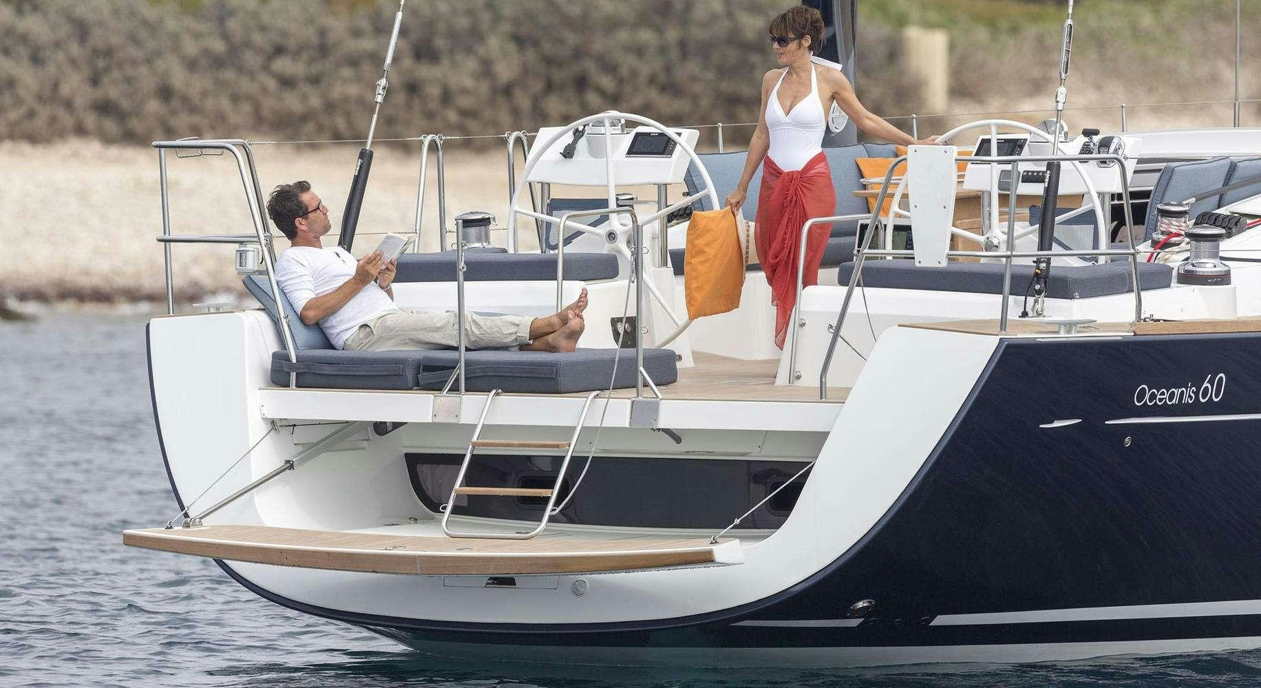 a man and woman sitting on a boat aboard OCEAN STAR Yacht for Charter