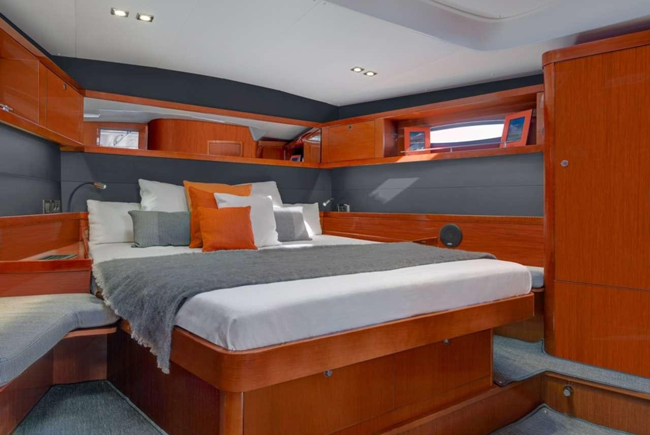 a room with a bed and a desk aboard OCEAN STAR Yacht for Charter