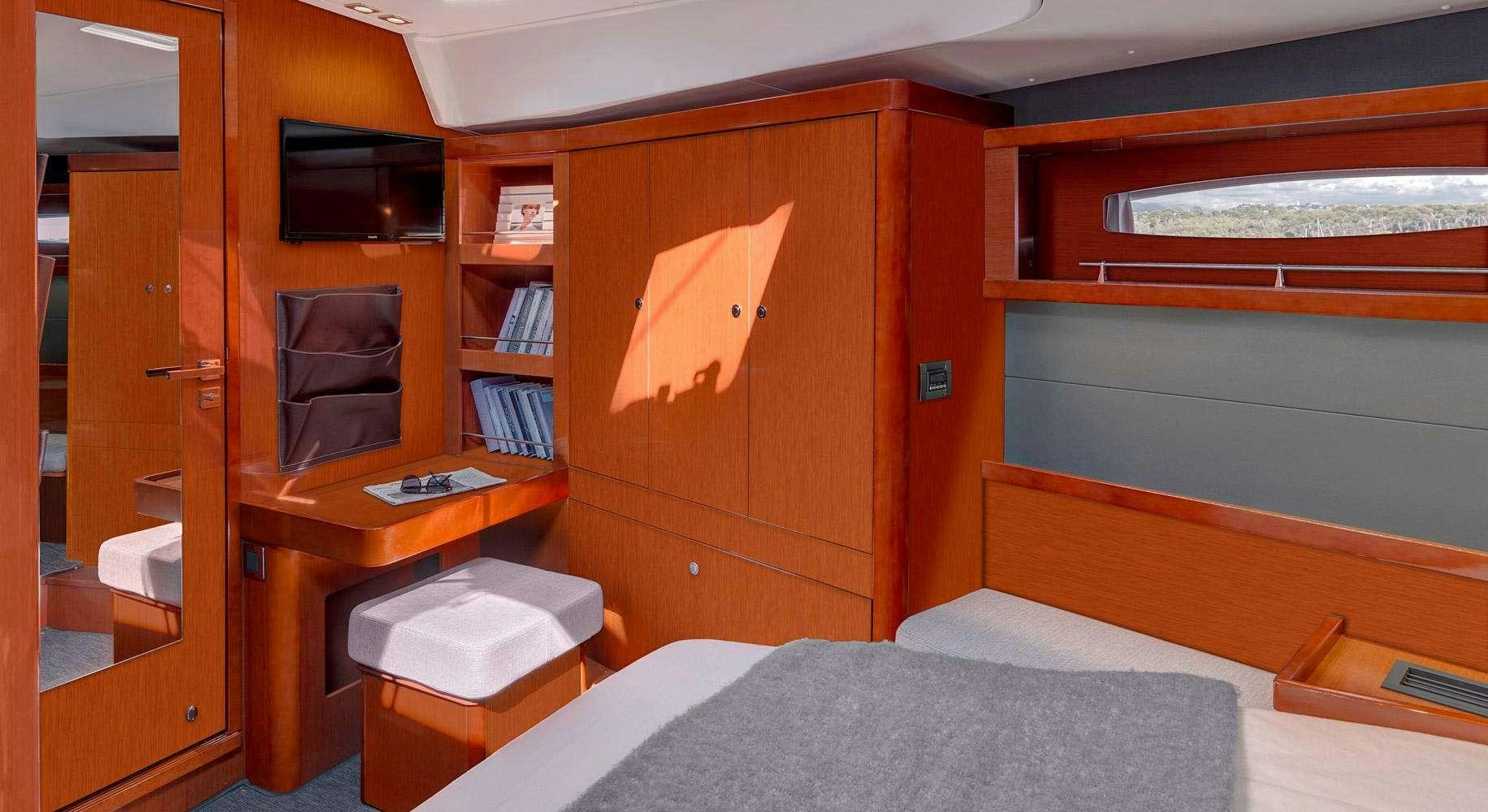 a bedroom with a bed and a desk aboard OCEAN STAR Yacht for Charter